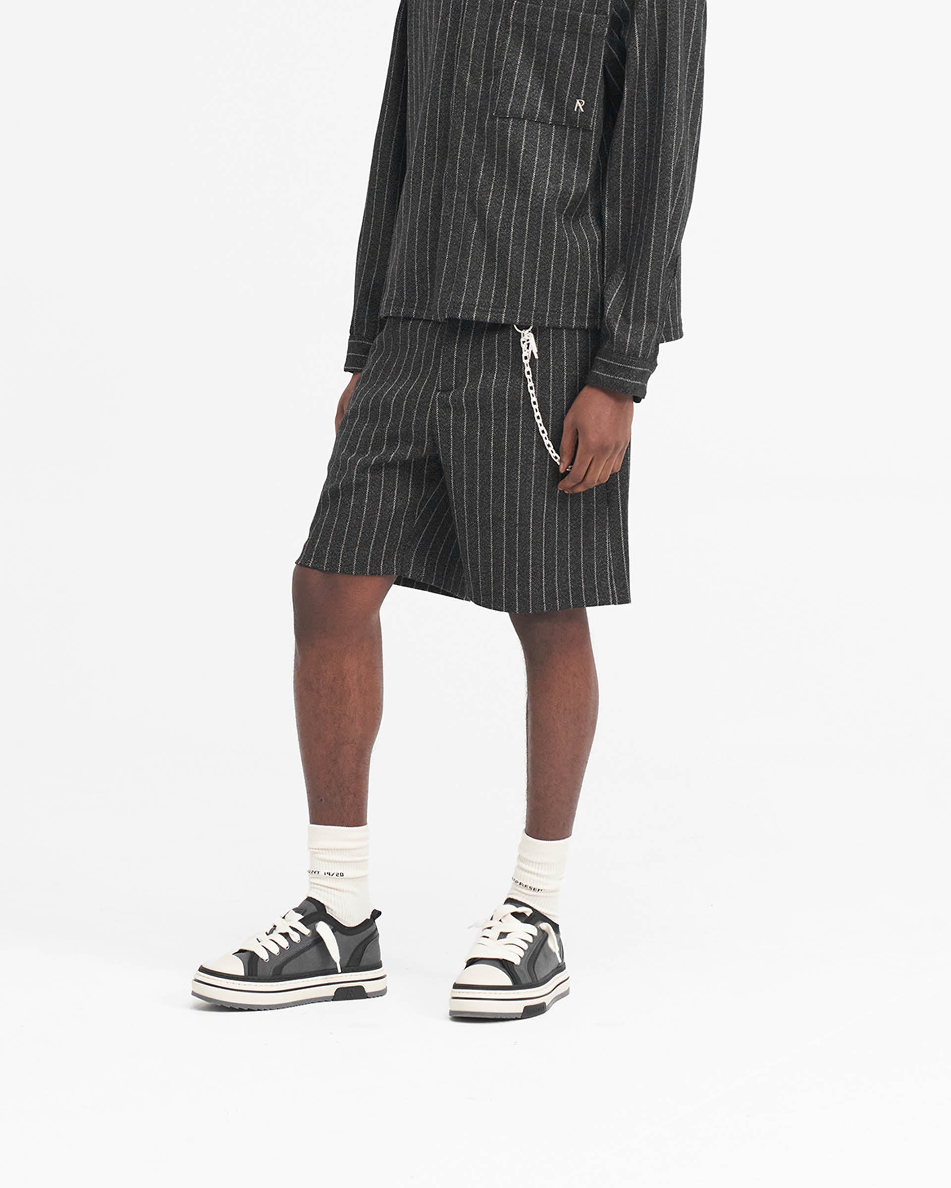 Back product image of mens black pinstripe shorts on a plain white background | Tailored Short in Black Pinstripe | Wide leg shorts with tailored waistband and side seam pockets | SS24 Shorts | Represent Clo