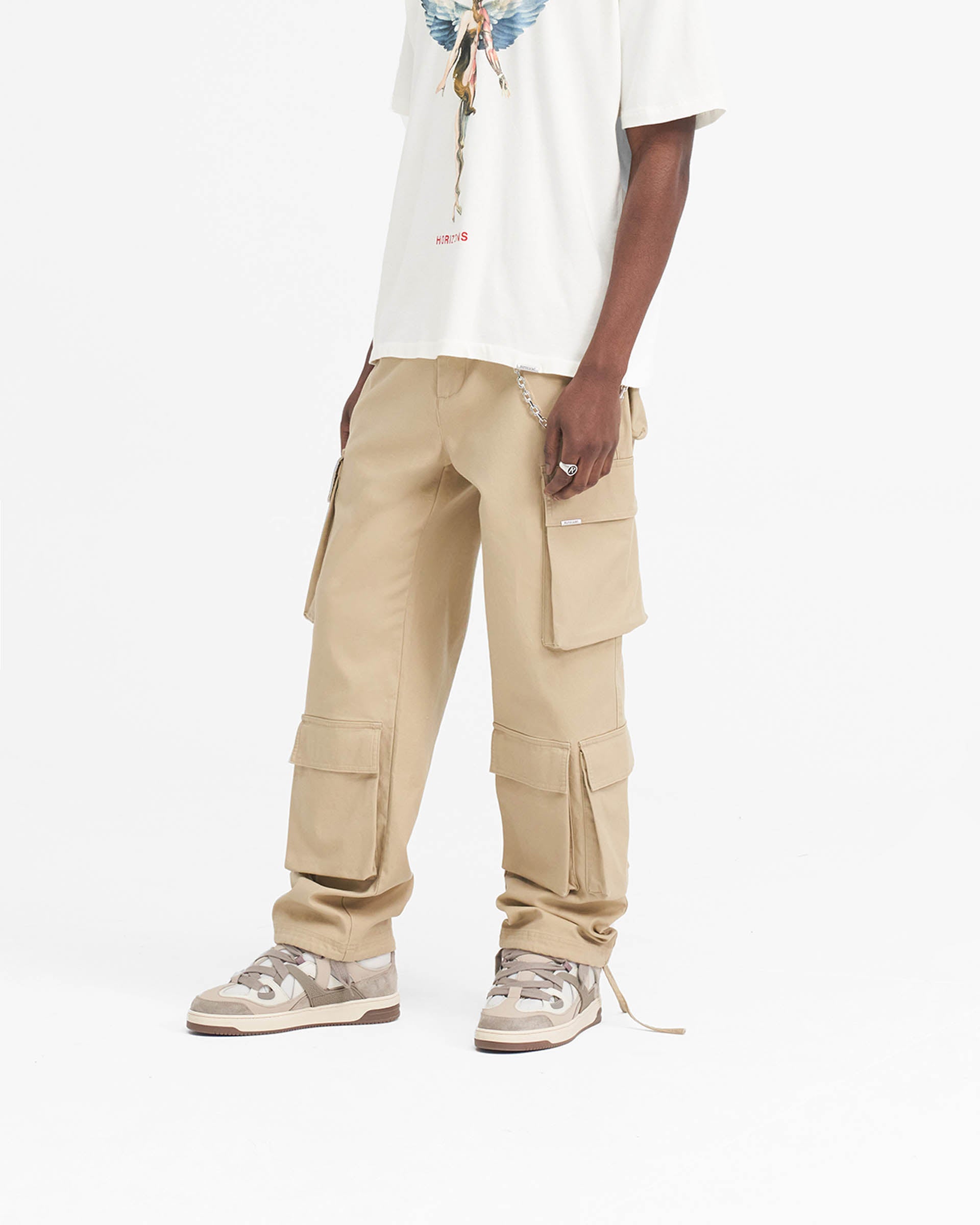 Back product image of mens beige cargo pants on a plain white background | Baggy Cargo Pant in Sandstone | Baggy fit pants with 3D oversized pockets | SS24 Pants | Represent Clo