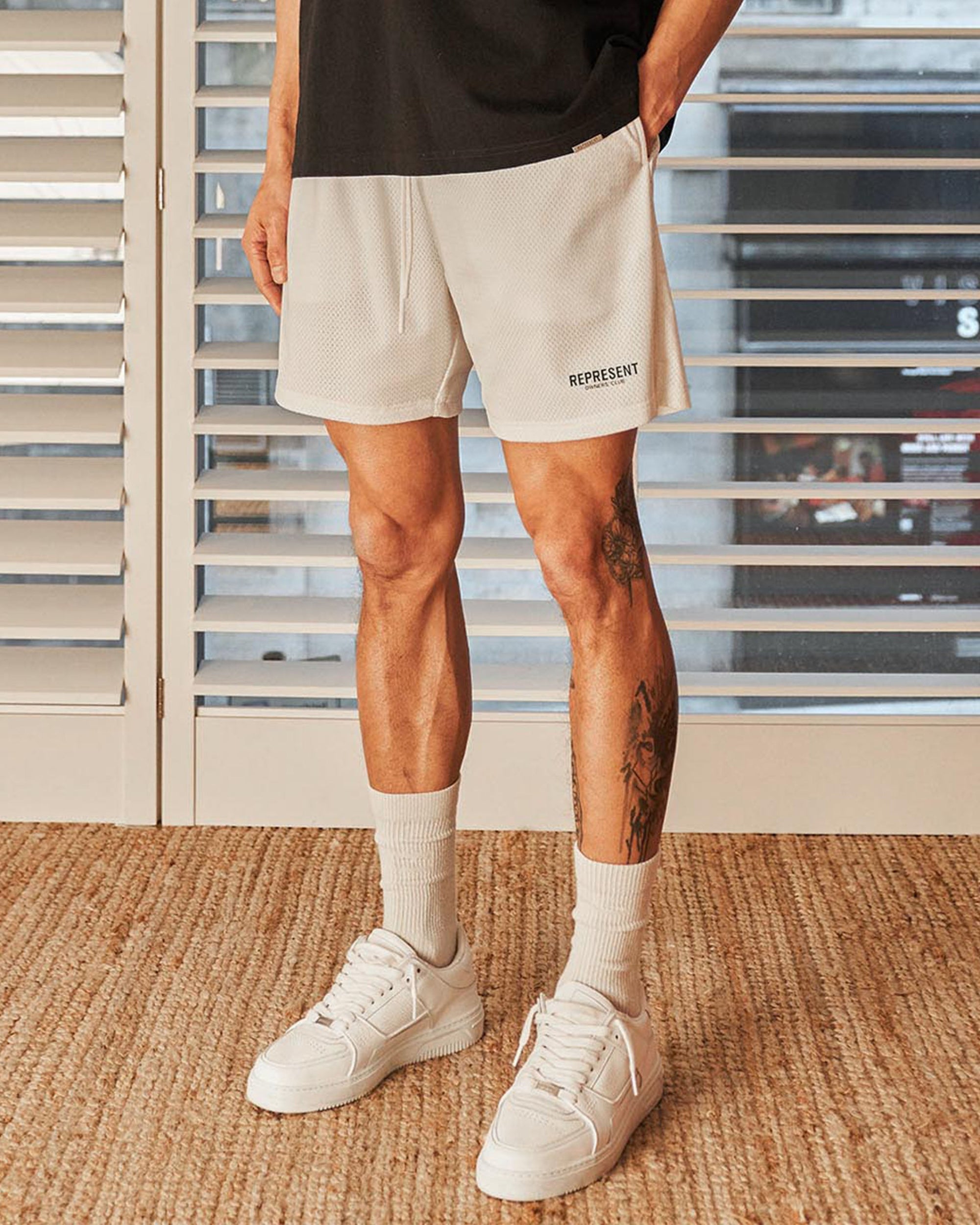 Back product image of flat white mens mesh shorts on a plain white background | Owners Club Mesh Shorts in Flat White | Relaxed fit mesh shorts with elasticated waist | Owners Club Shorts | Represent Clo