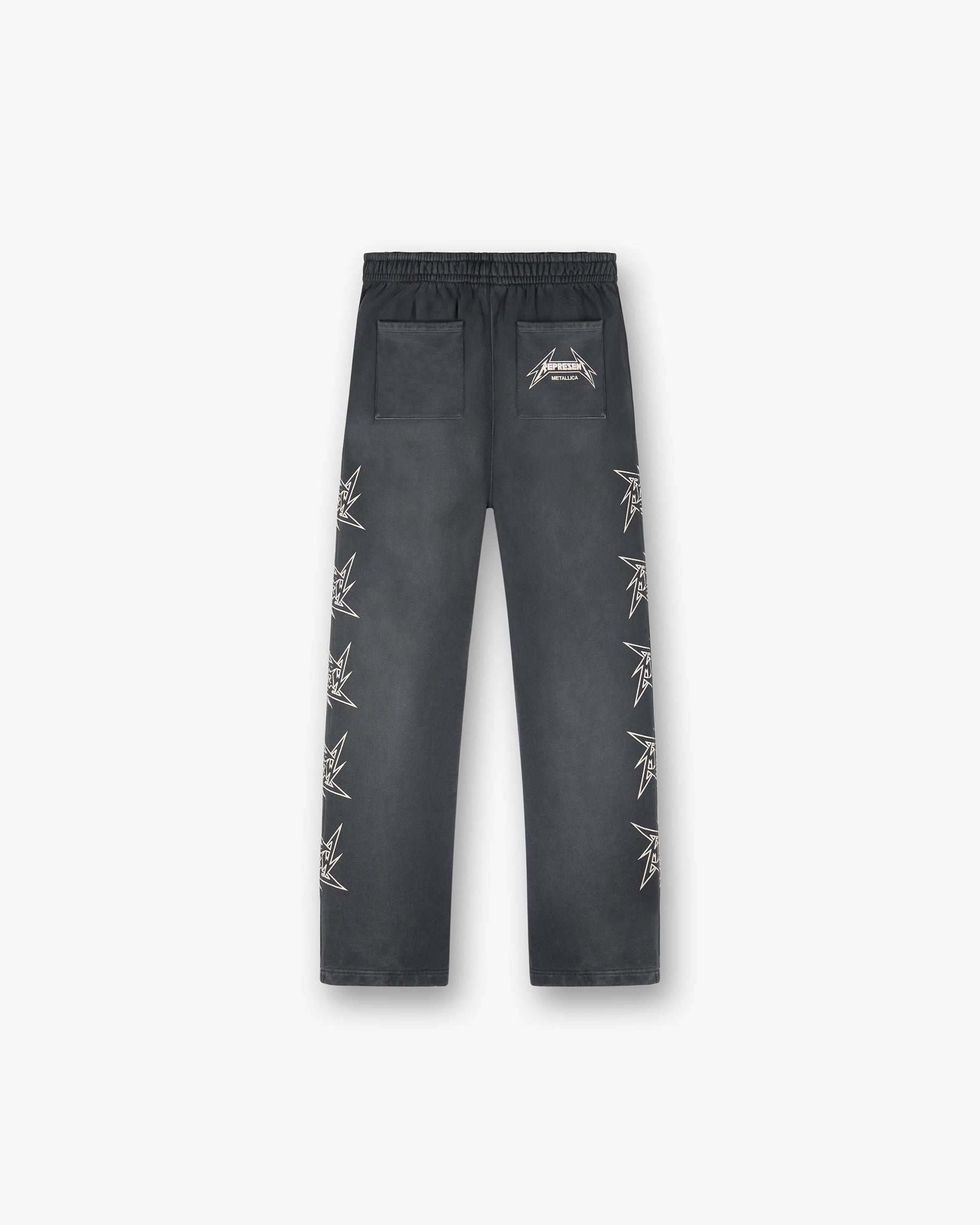 Back product image of mens black sweatpants on a plain white background | Represent X Metallica Local Crew Sweatpant in Stained Black | Sweatpants with cracked print logos and elasticated waistband | SS24 Pants | Represent Clo