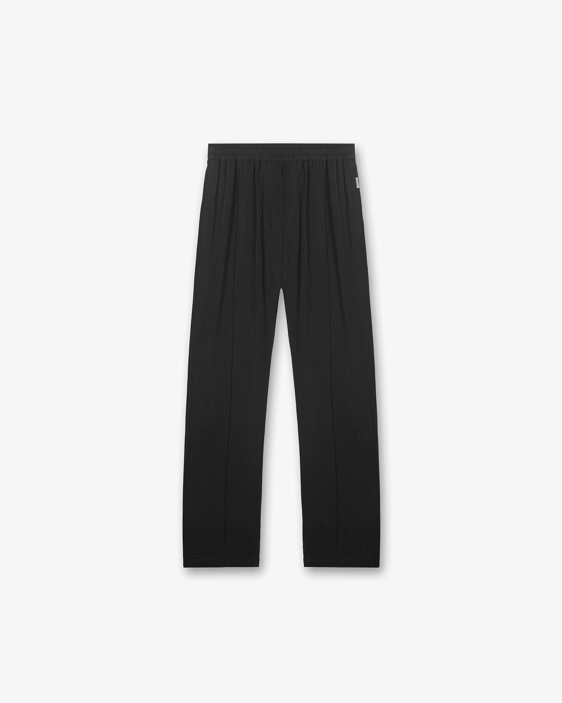 Front product image of a mens black track pant on a plain white background | Initial Track Pant in Black | Track pant with baggy fit and 3D oversized pockets | Initial Pants | Represent Clo