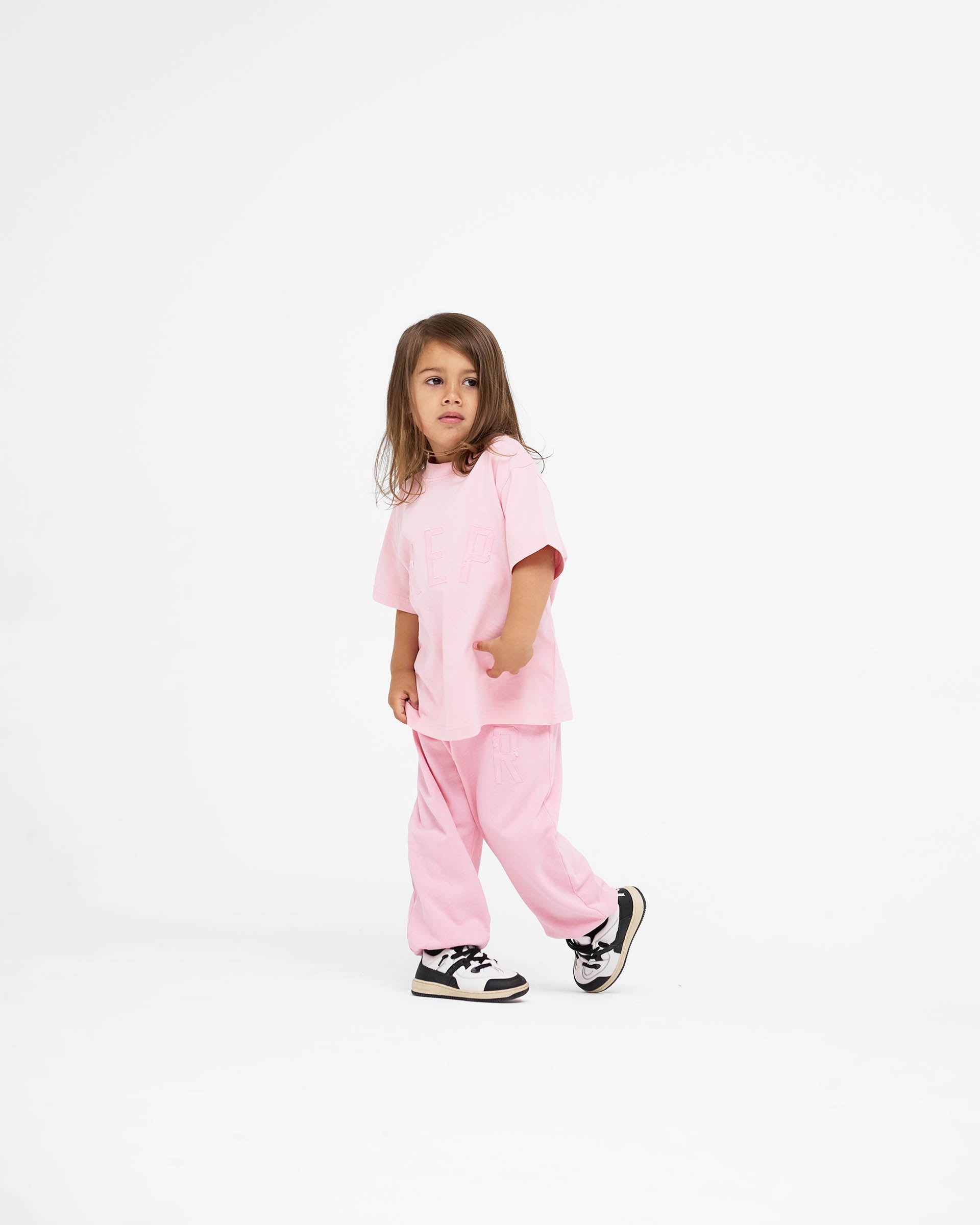 Back product image of a kids pink t-shirt on a plain white background | Mini Rep Applique T-Shirt in Candy Pink | Kids t-shirt with oversized fit and distressed logo | FW24 T-Shirts | Represent Clo