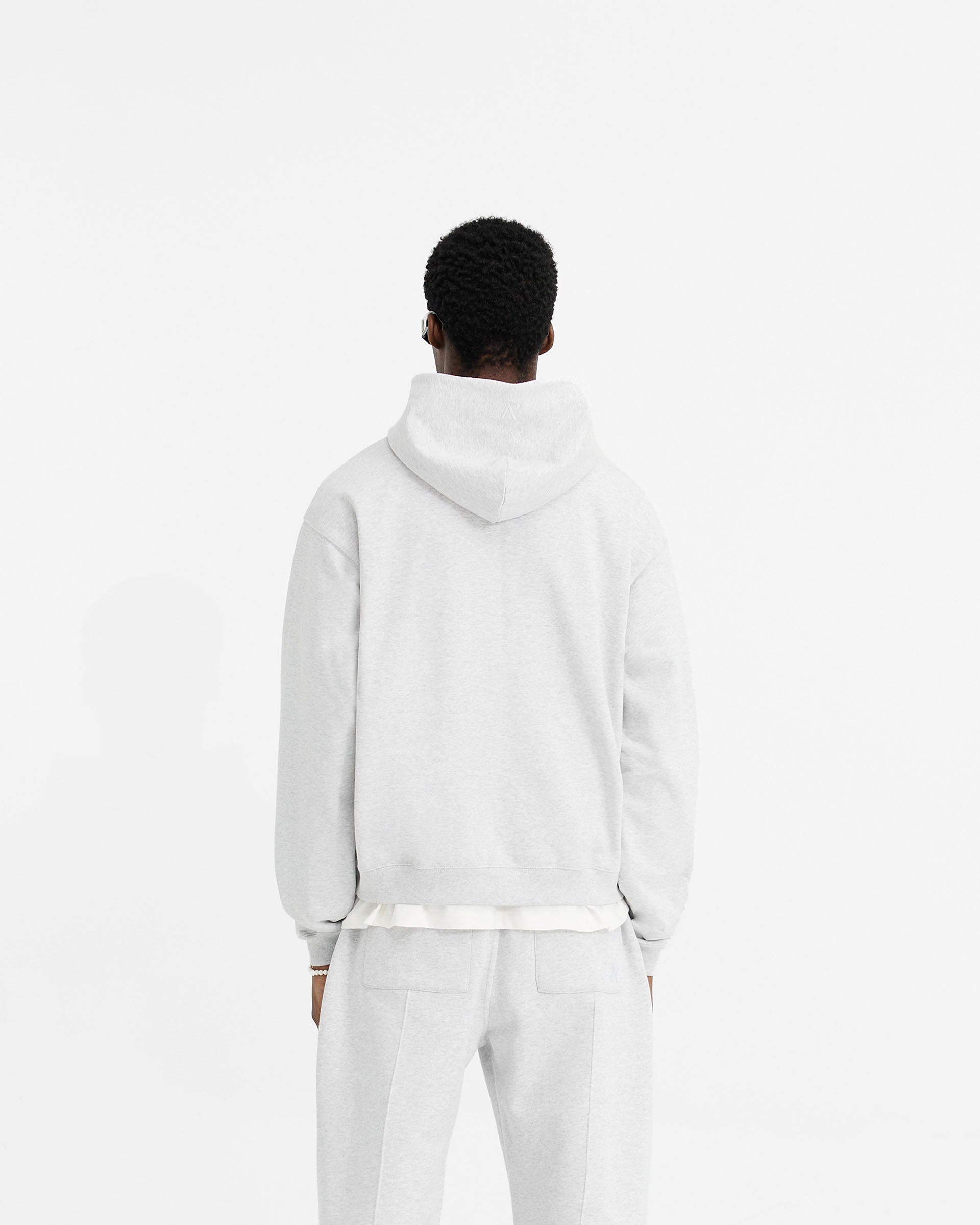 Man wearing a grey zip hoodie on a plain white background | Initial Oversized Zip Hoodie in Ice Grey Marl | Oversized fit with front zip closure | Initial Hoodies | Represent Clo