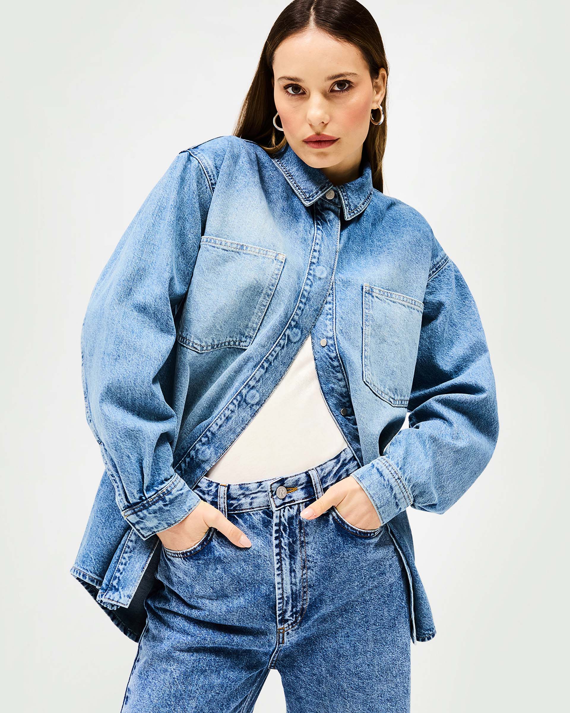 Back product image of a womens blue denim overshirt on a plain white background | Denim Overshirt in Washed Blue | Oversized fit with popper fastening | Womens SS25 Denim | Represent Clo