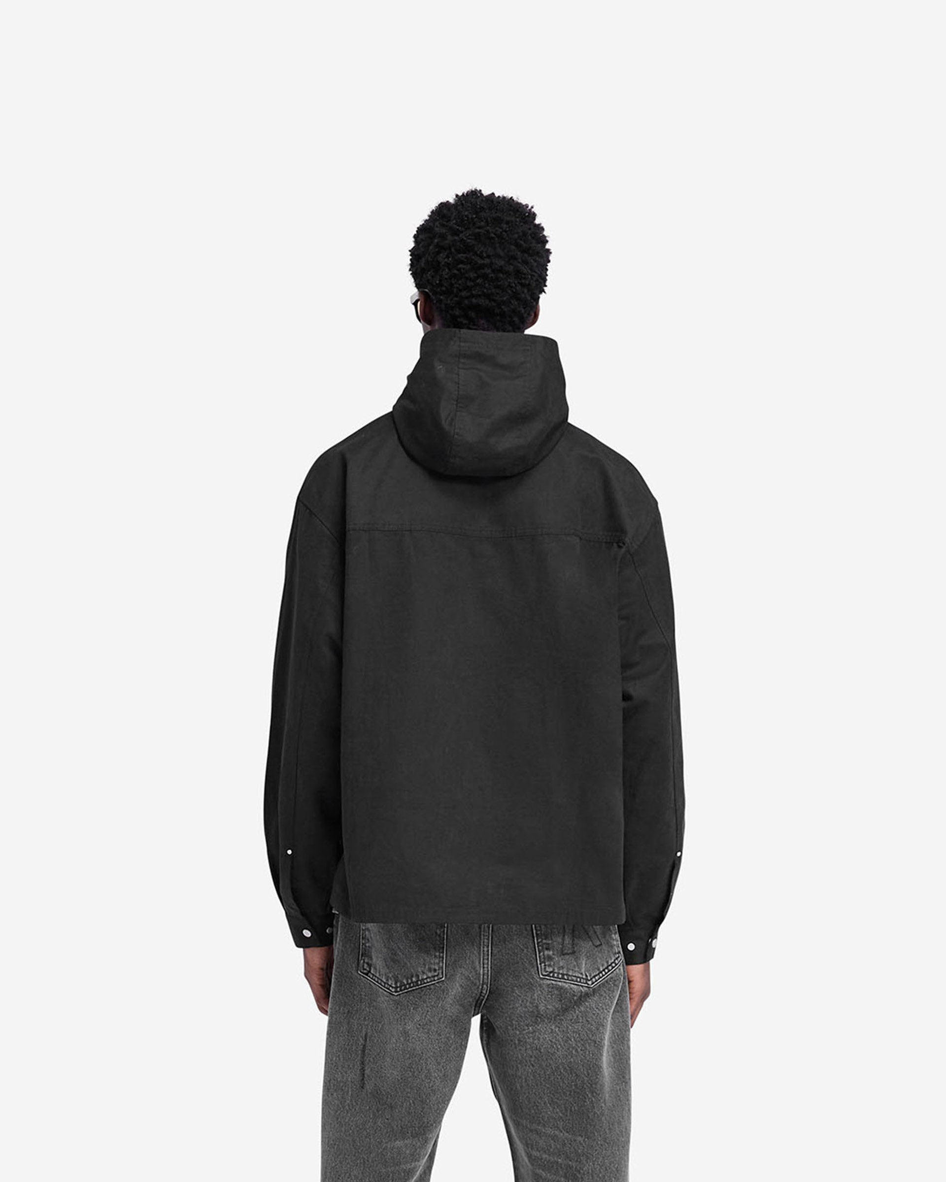 Man wearing a black utility hooded shirt on a plain white background | Utility Hooded Shirt in Jet Black | Hooded shirt with front and side seam pockets | FW24 Shirts | Represent Clo