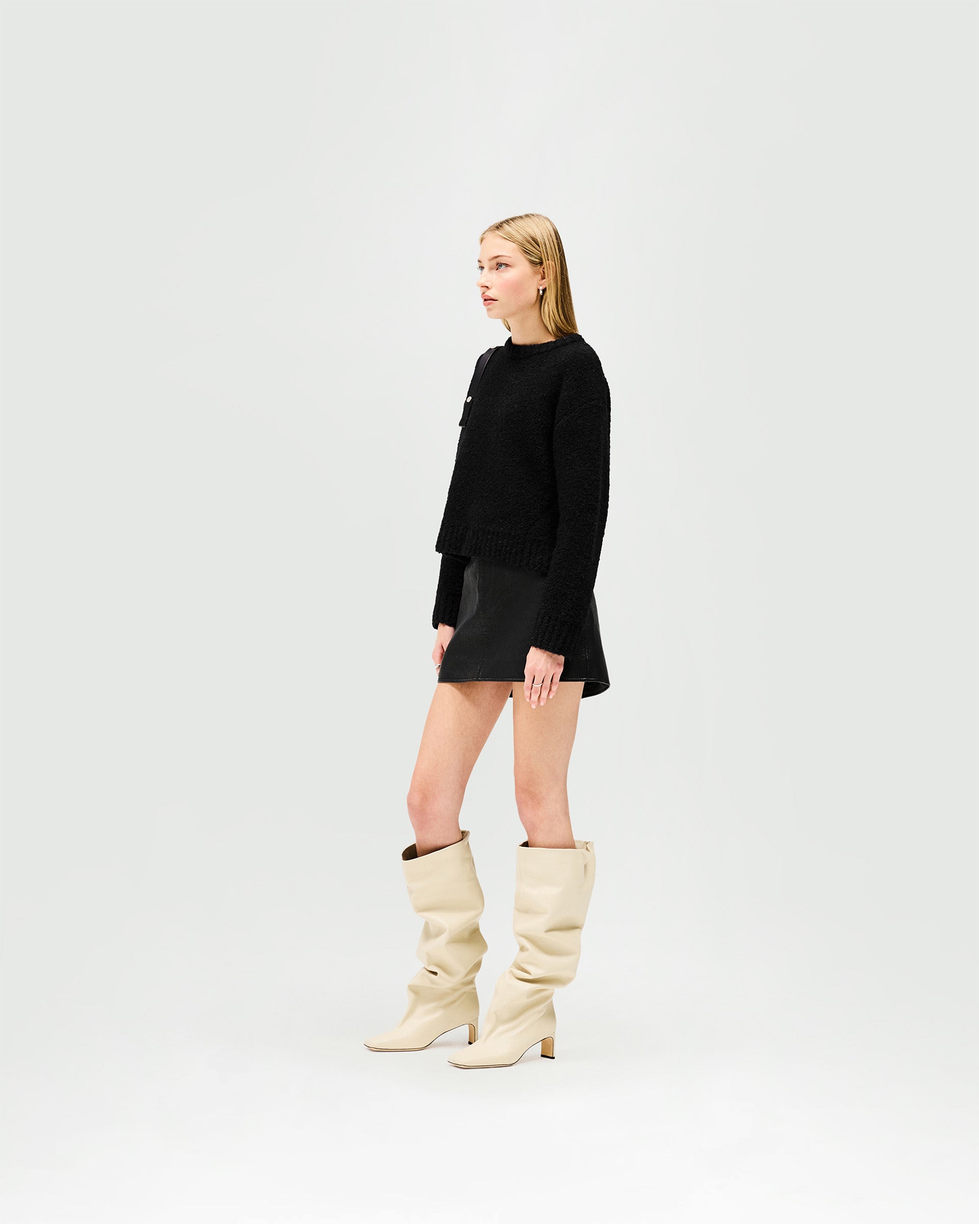 Back product image of a womens black leather skirt on a plain white background | Drive Skirt in Jet Black | Bubble leather mini skirt with zip fly | Womens SS25 Skirts | Represent Clo