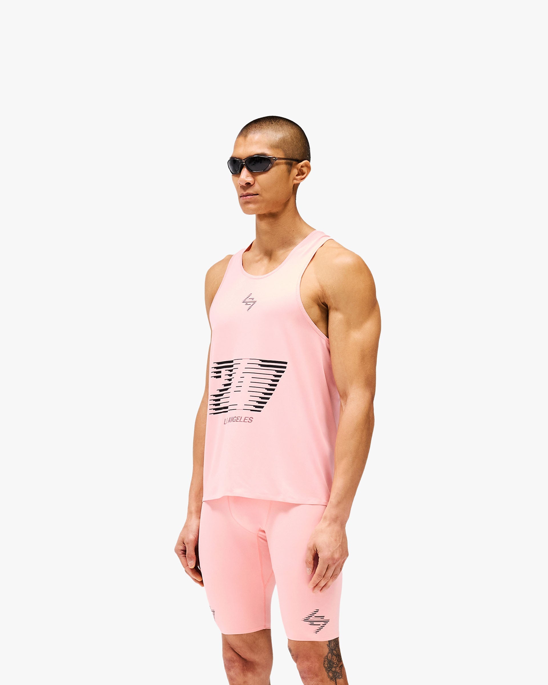 Man wearing a pink singlet on a plain white background | 247 Los Angeles Singlet in Pink | Lightweight breathable singlet with honeycomb mesh back | 247 T-Shirts | Represent Clo