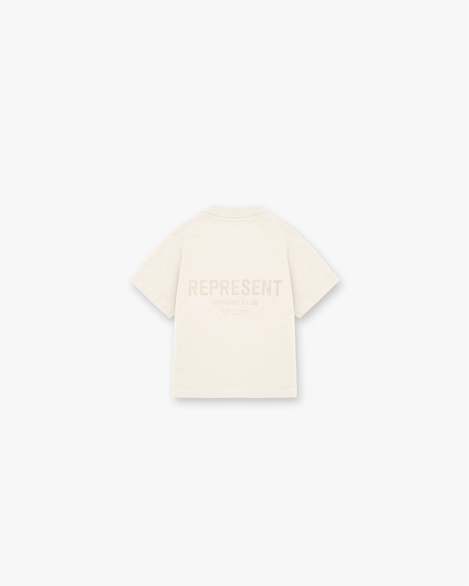 Back product image of a kids cream t-shirt on a plain white background | Represent Mini Owners Club T-Shirt in Buttercream | Slightly oversized kids t-shirt with screen printed graphic | Mini Owners Club T-Shirts | Represent Clo