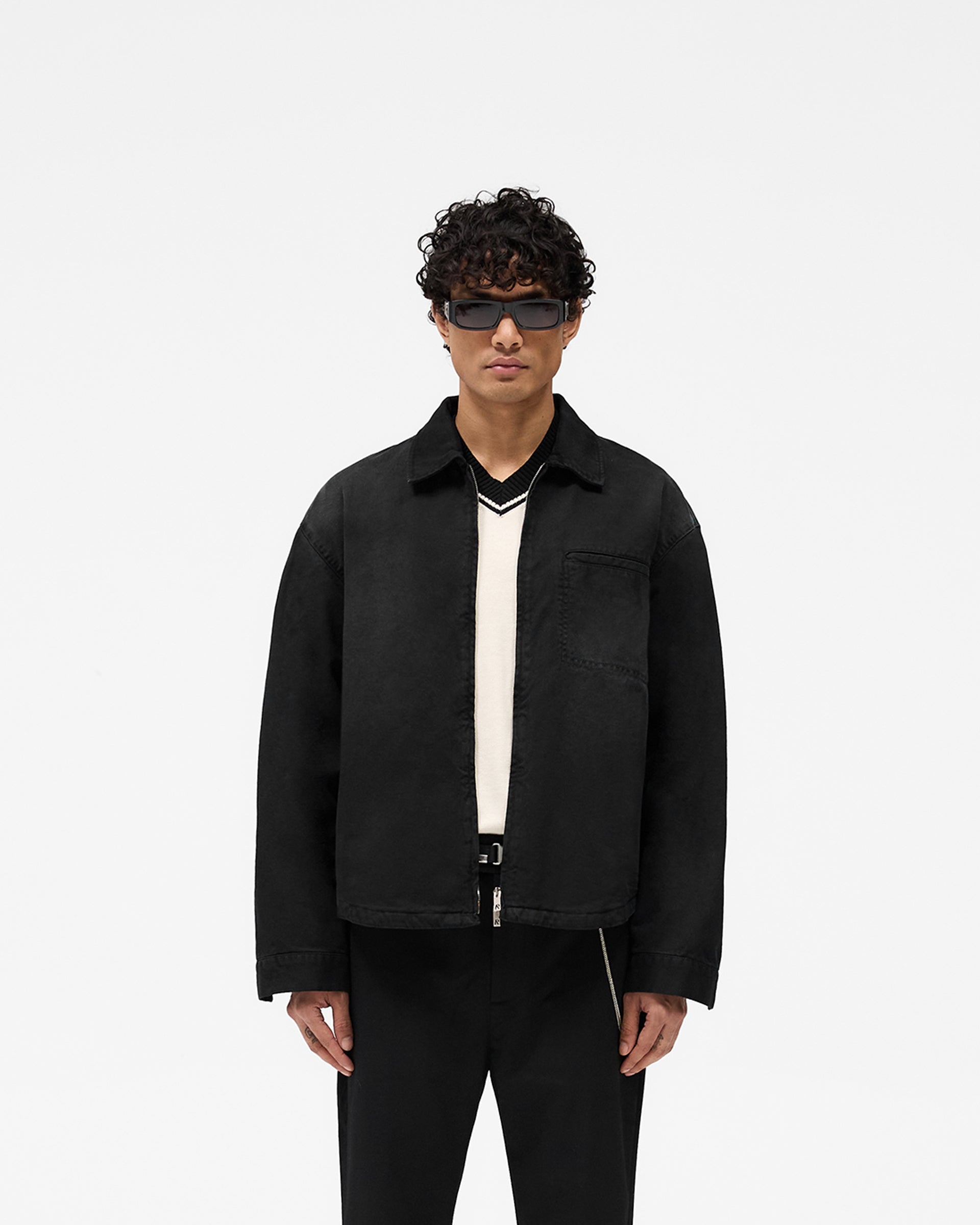 Man wearing a black cotton shirt on a plain white background | Cotton Zip Through Shirt in Black | Shirt with double zips and chest pocket | SS25 Shirts | Represent Clo