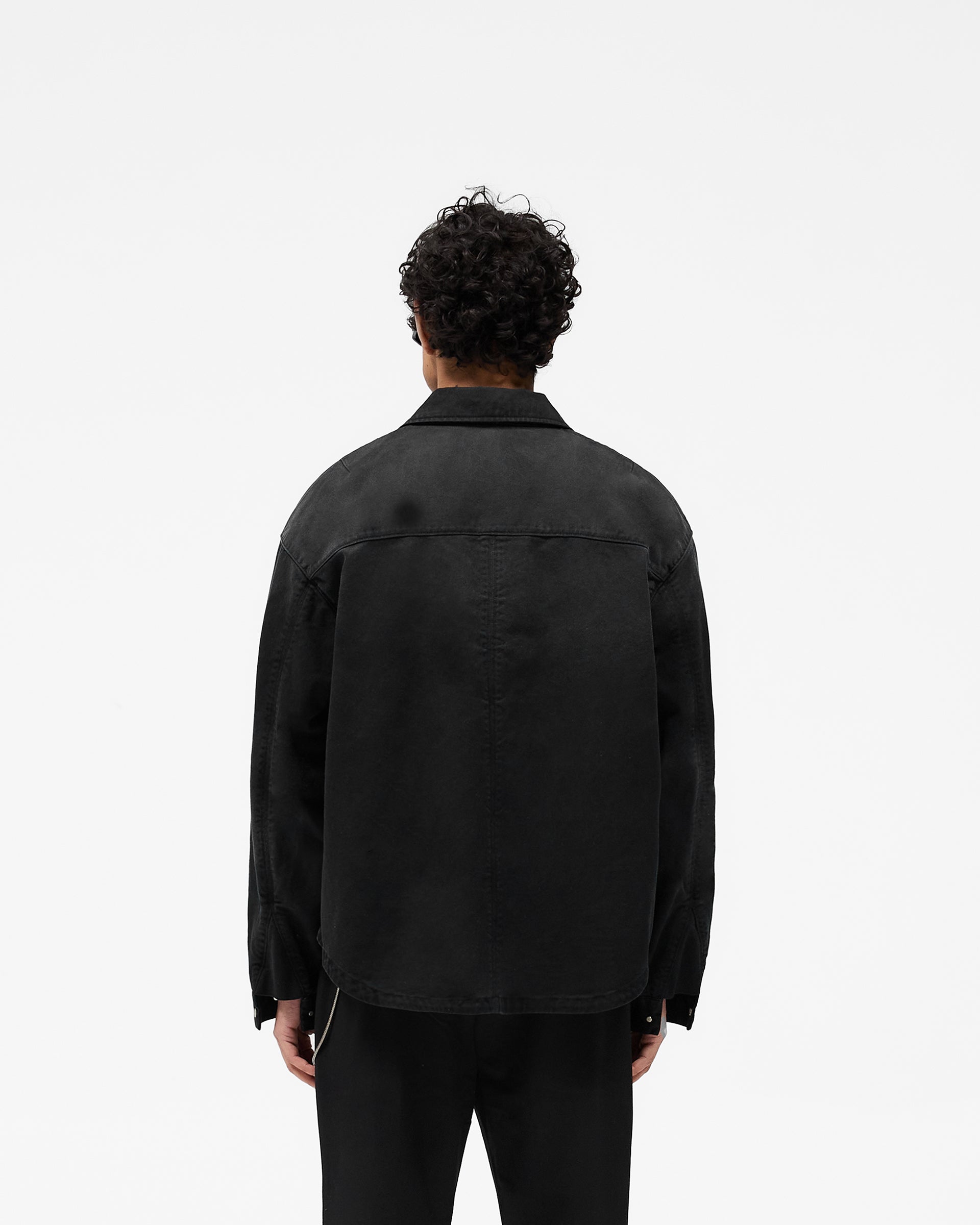 Man wearing a black zip through shirt on a plain white background | Cotton Zip Through Shirt in Black | Shirt with double zips and chest pocket | SS25 Shirts | Represent Clo