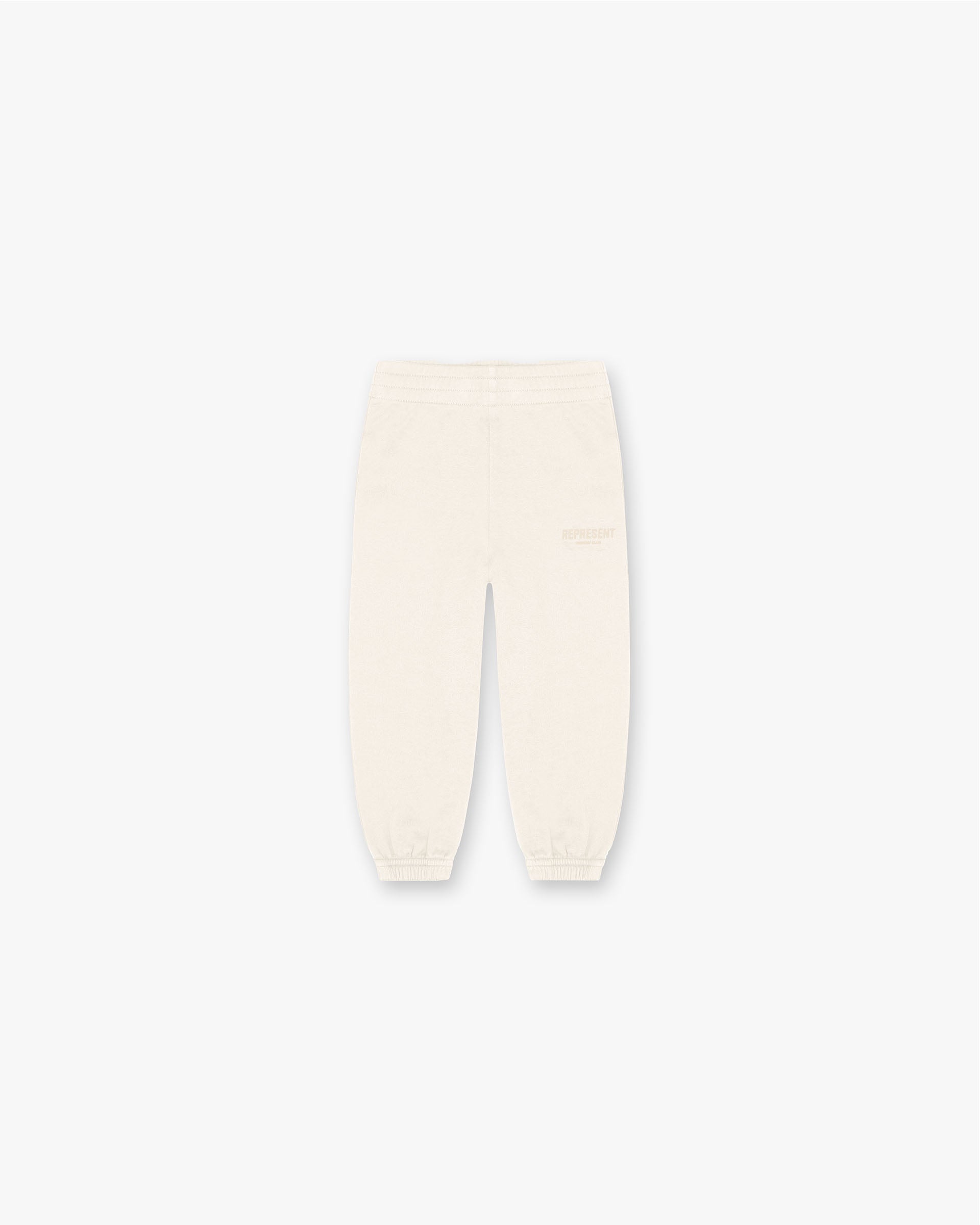 Front product image of a child's cream sweatpants on a plain white background | Mini Owners Club Sweatpants in Buttercream | Soft pants with elastic waistband | SS23 Pants | Represent Clo