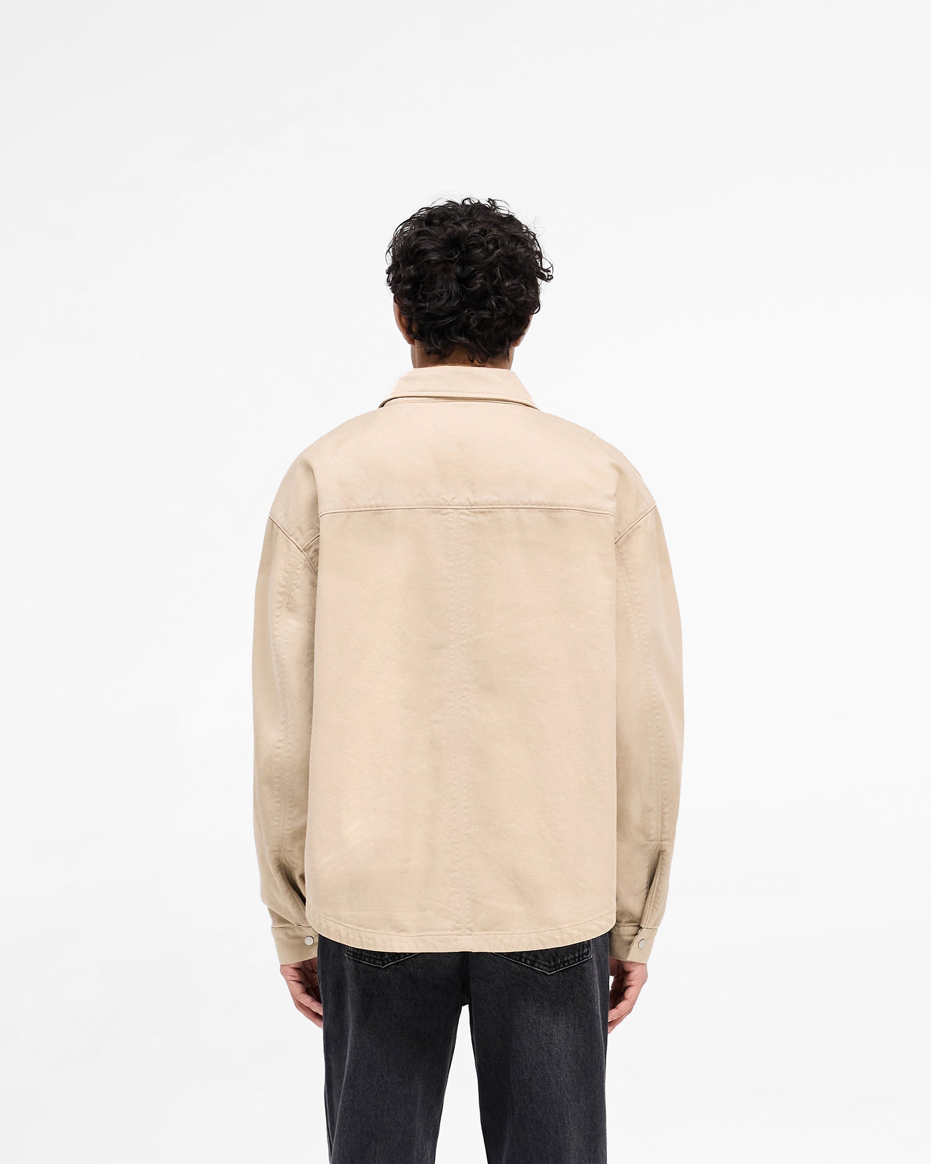 Man wearing a beige cotton shirt on a plain white background | Cotton Zip Through Shirt in Beige | Cotton twill shirt with double zips | SS25 Shirts | Represent Clo
