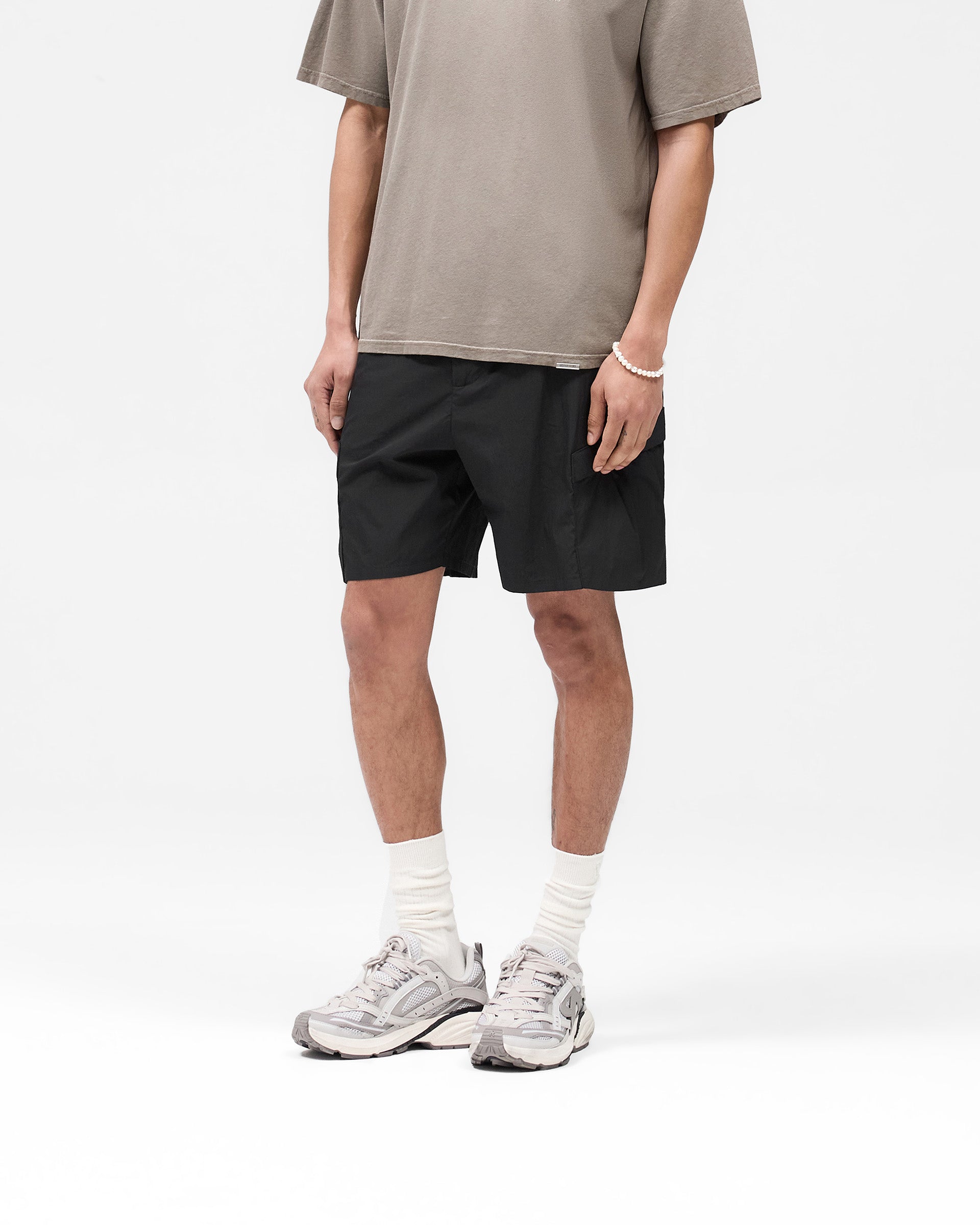 Back product image of mens black shorts on a plain white background | Tech Cargo Short in Jet Black | Cargo shorts with pleated pockets and hybrid waistband | SS25 Shorts | Represent Clo