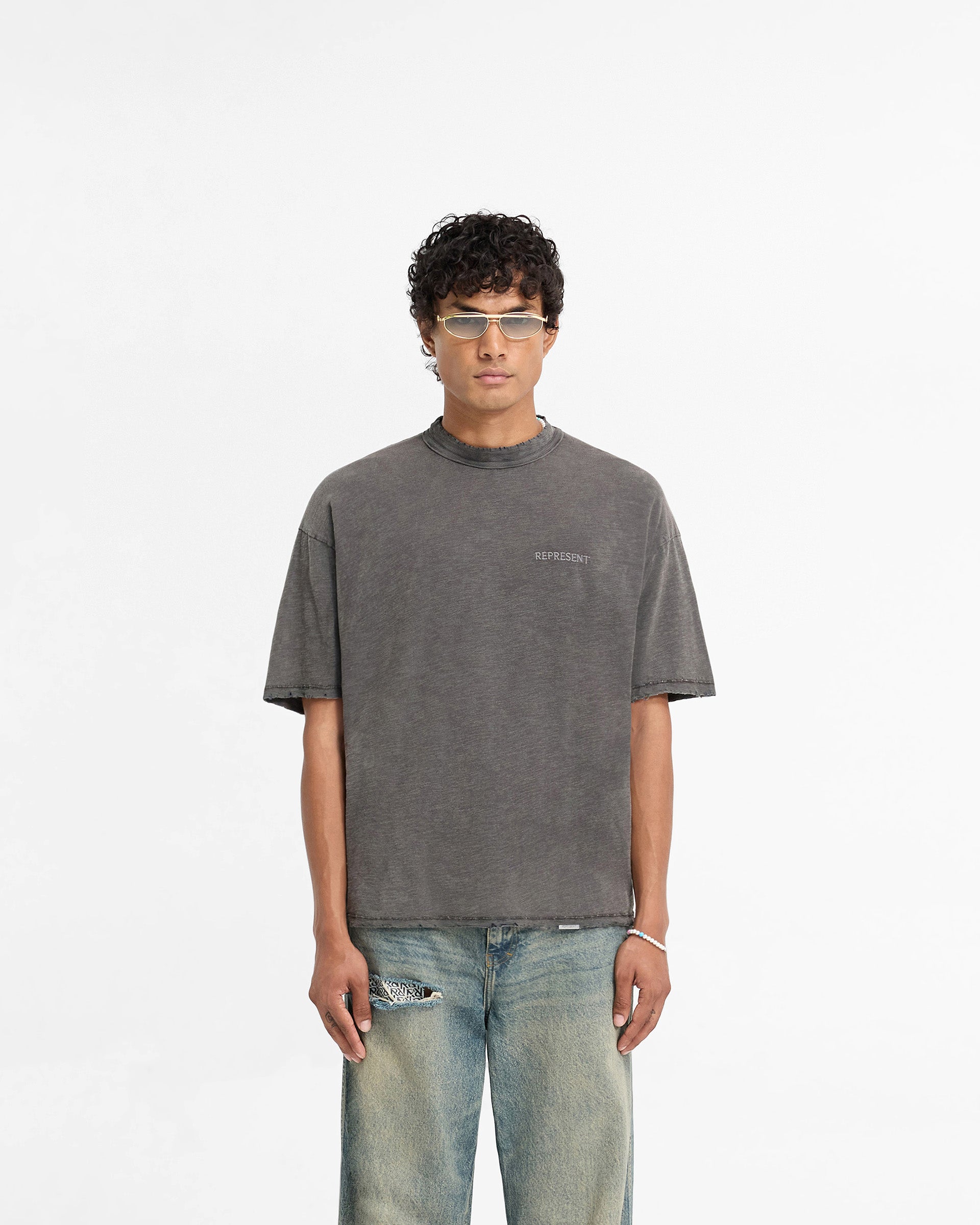 Man wearing a slightly oversized grey t-shirt on a plain white background | Slub T-Shirt in Vintage Grey | Slub cotton t-shirt with tonal embroidery | FW24 T-Shirts | Represent Clo