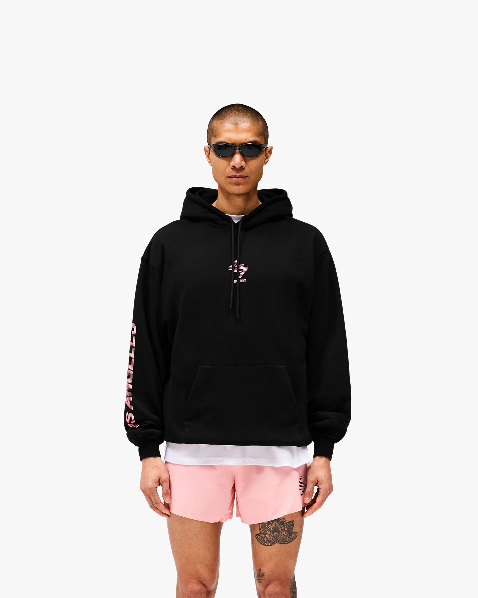 Man wearing an oversized black hoodie on a plain white background | 247 Los Angeles Hoodie in Jet Black | Oversized hoodie with ribbed cuffs and tonal drawcords | 247 Hoodies | Represent Clo