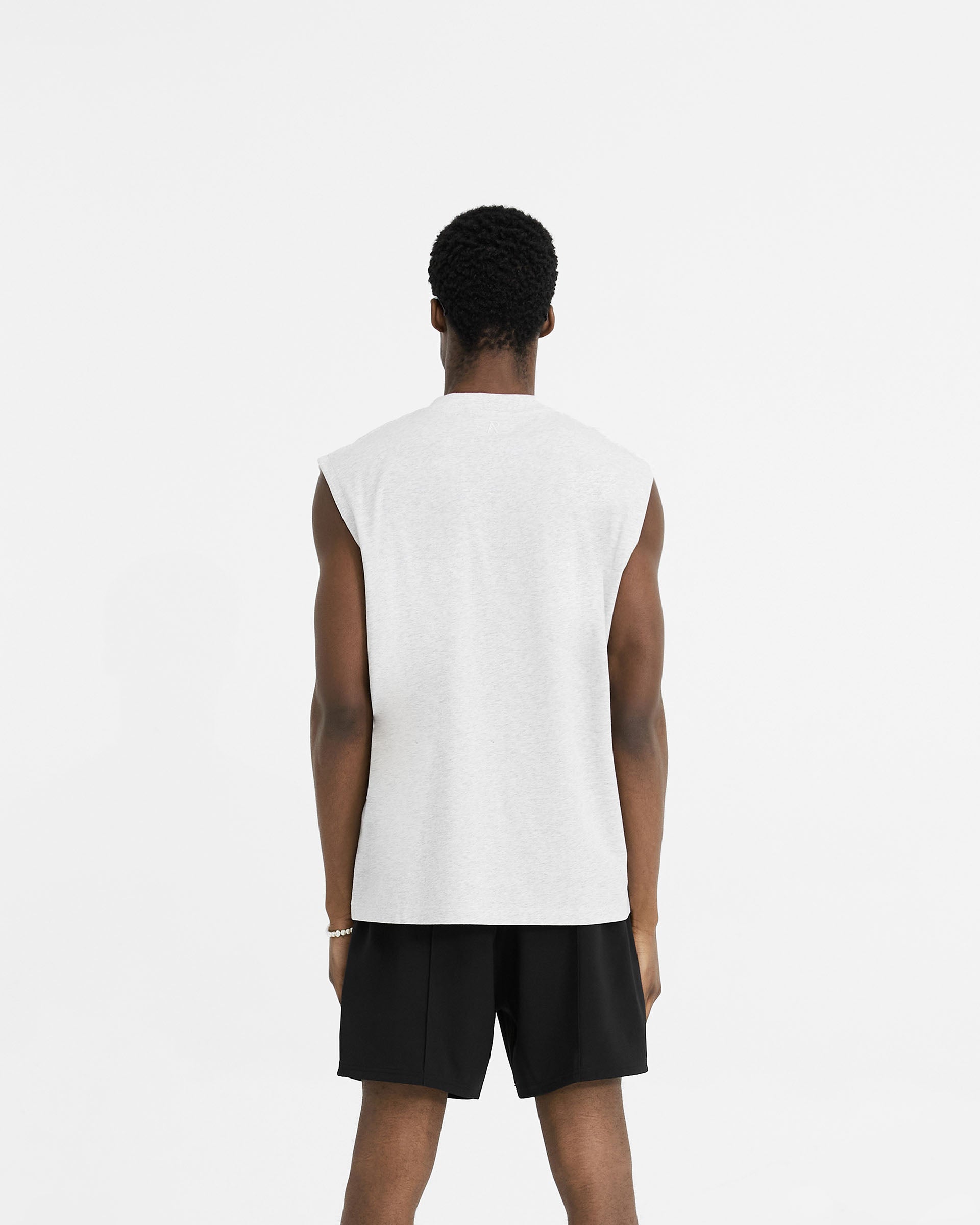 Man wearing a grey oversized tank on a plain white background | Initial Boxy Tank in Ice Grey Marl | Super oversized boxy cropped tank top | Initial T-Shirts | Represent Clo