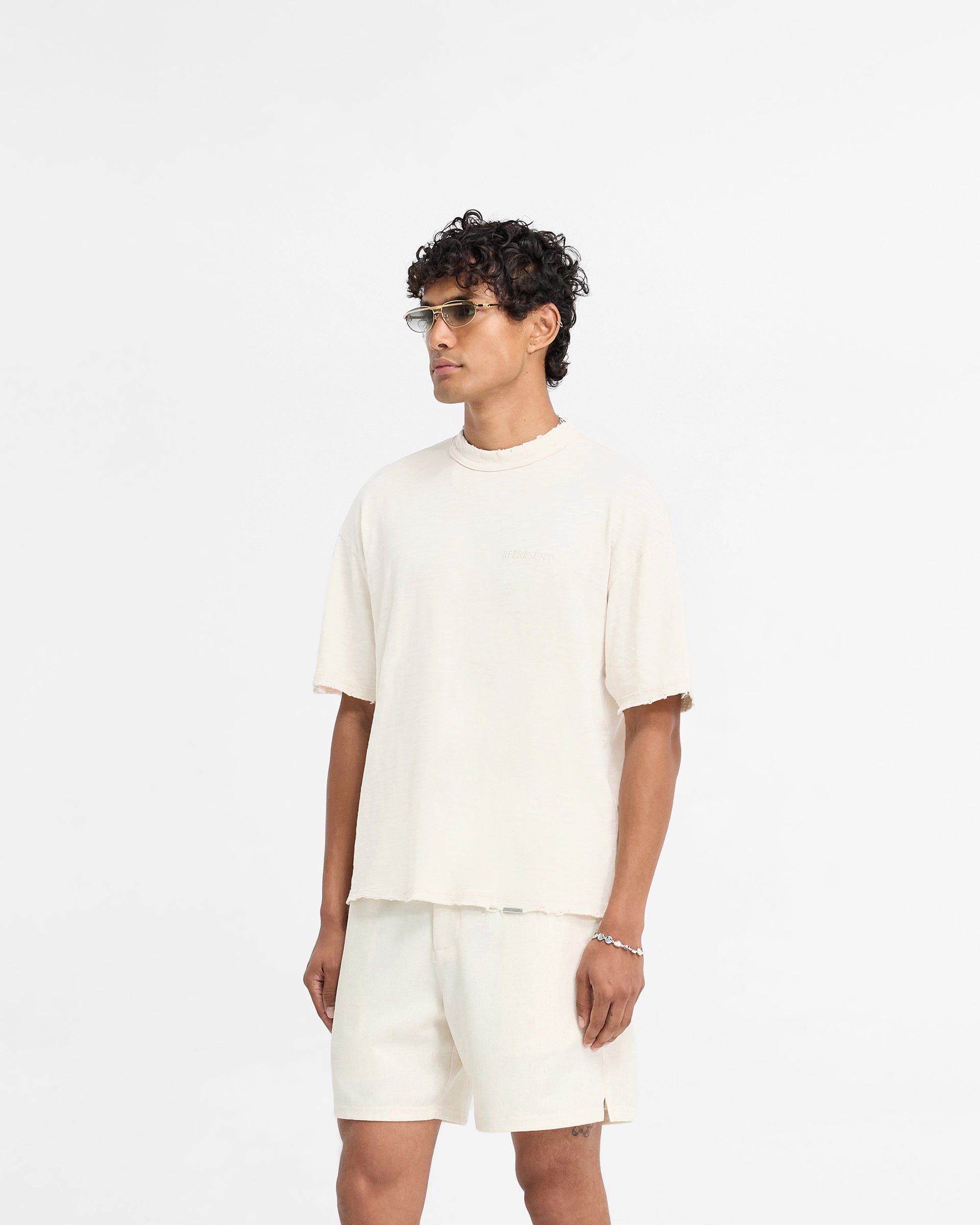 Back product image of a mens white t-shirt on a plain white background | Slub T-Shirt in Flat White | Oversized fit t-shirt with tonal embroidery and distressed details | FW24 T-Shirts | Represent Clo