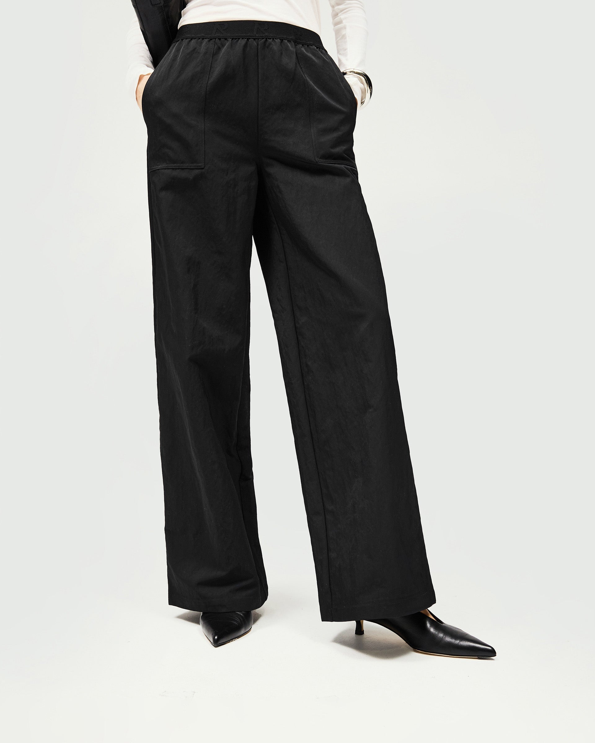 Back product image of a womens black jogger on a plain white background | Subway Jogger in Jet Black | Nylon jogger with crinkle texture and R Initial elastic waistband | SS25 Bottoms | Represent Clo