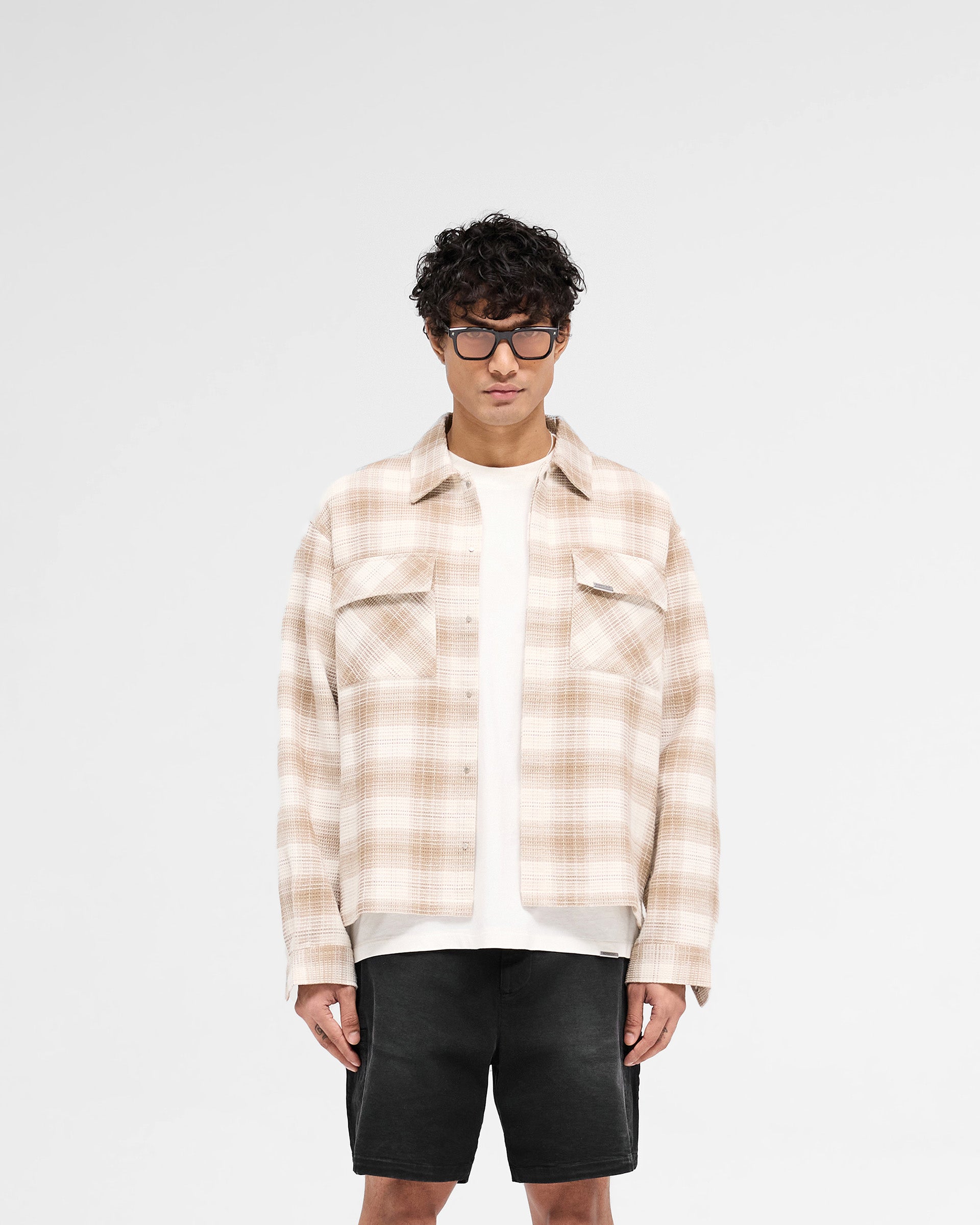 Man wearing a brown flannel shirt on a plain white background | Waffle Flannel Shirt in Mid Brown | Shirt with textured waffle fabric and double chest pockets | SS25 Shirts | Represent Clo