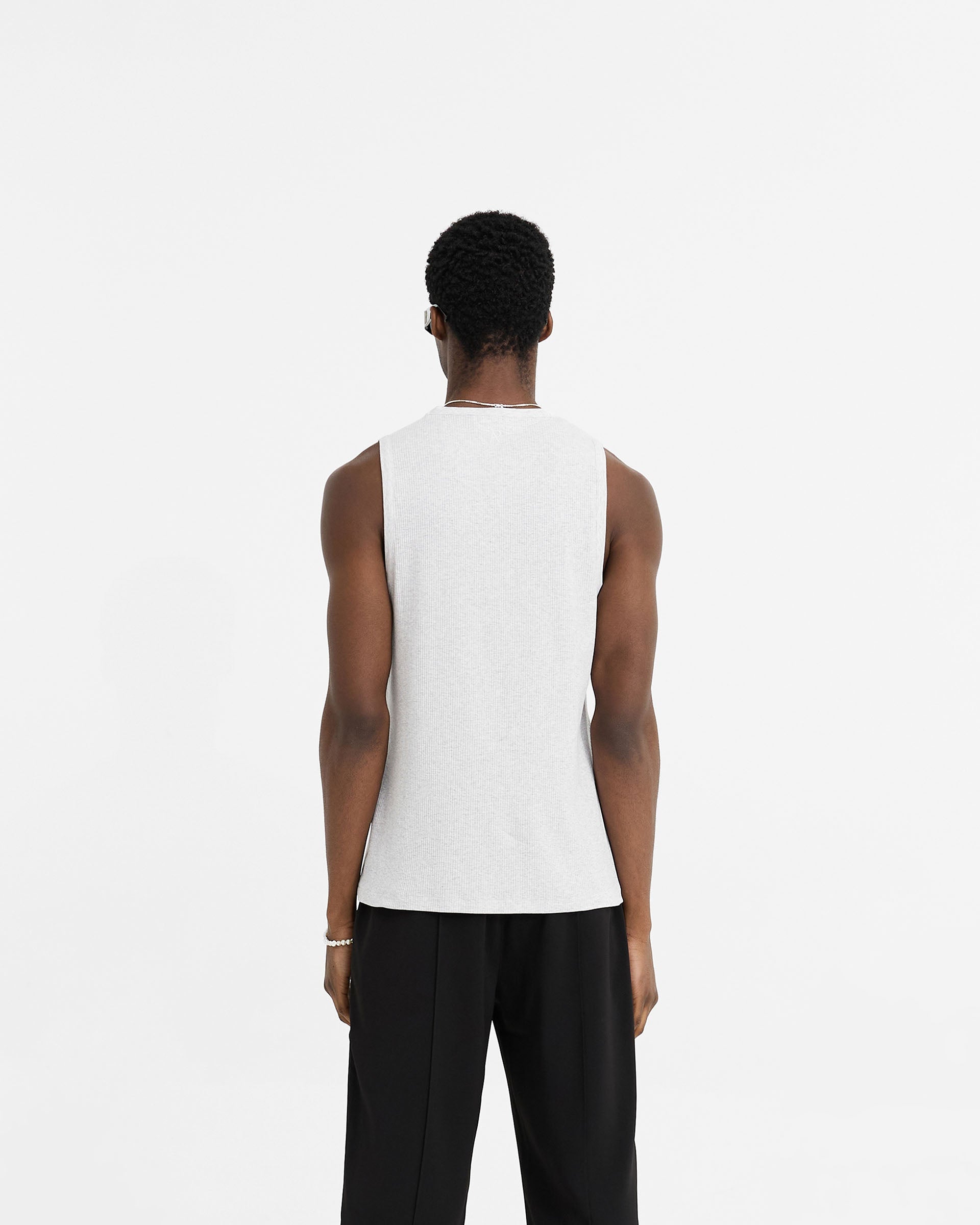 Man wearing a grey rib vest on a plain white background | Initial Rib Vest in Ice Grey Marl | Regular fit lightweight rib vest | Initial T-Shirts | Represent Clo
