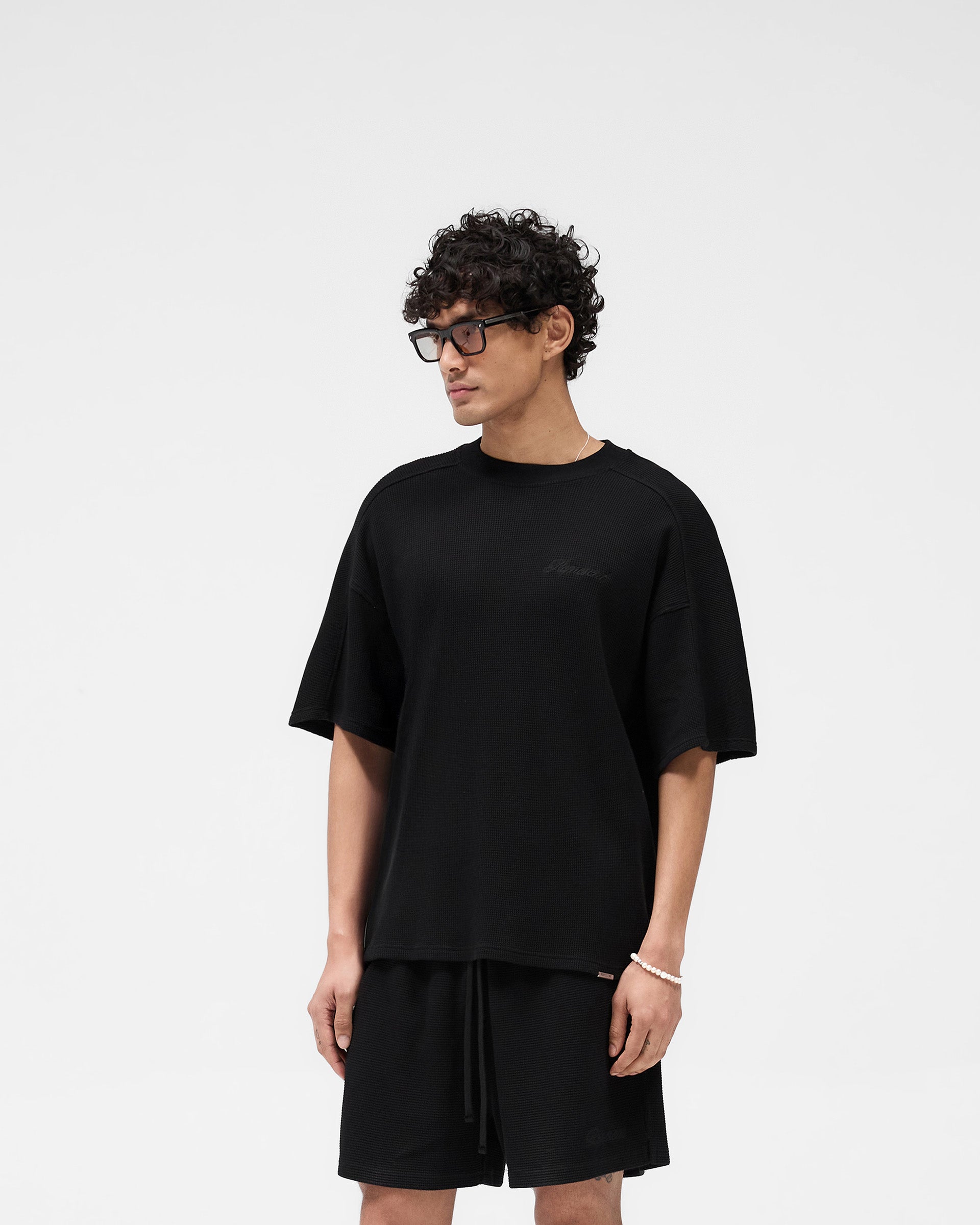 Back product image of a mens black t-shirt on a plain white background | Waffle T-Shirt in Jet Black | Textured cotton t-shirt with interlock waffle fabric | SS25 T-Shirts | Represent Clo