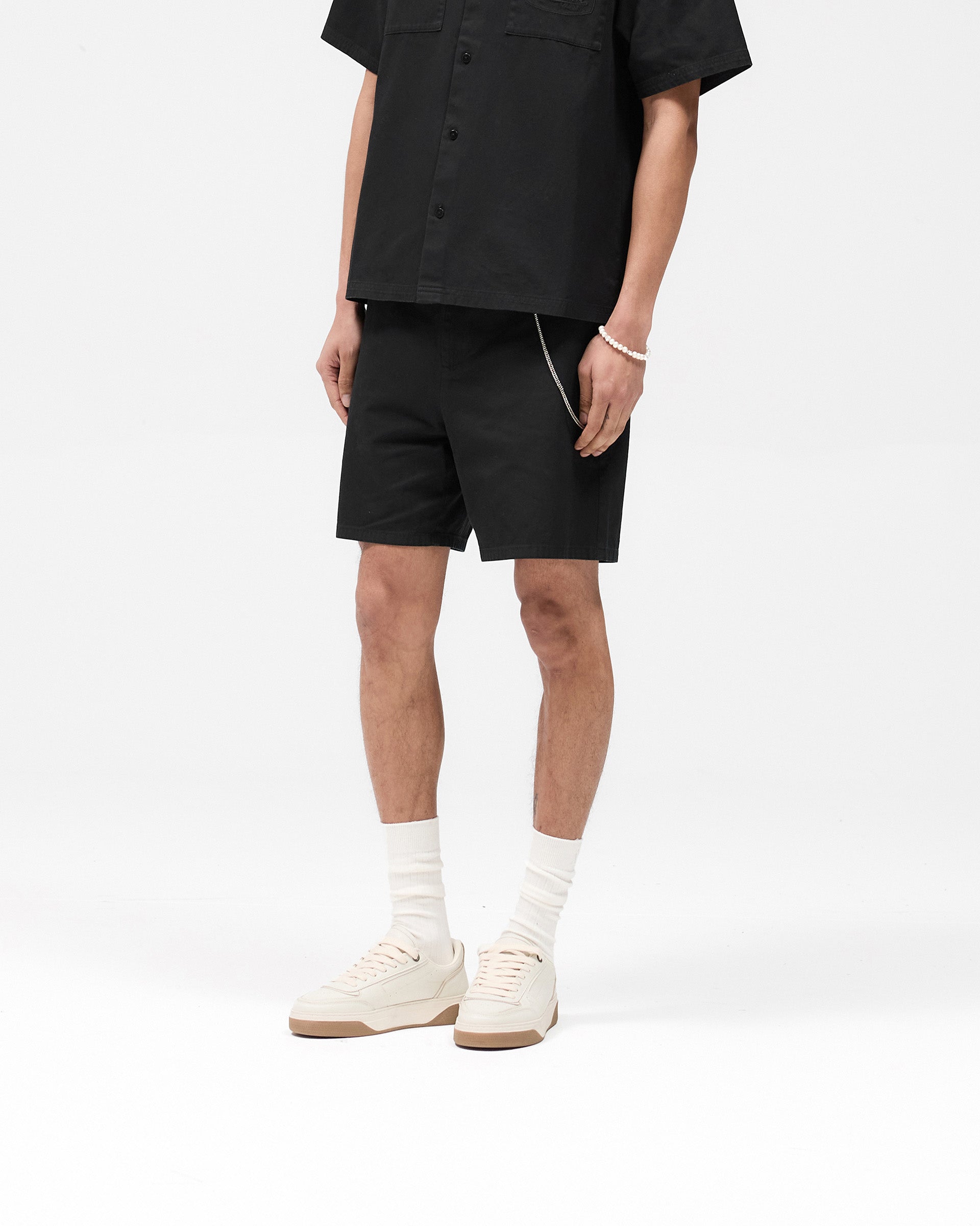 Back product image of mens black cotton shorts on a plain white background | Cotton Tailored Short in Jet Black | Cotton shorts with structured fit and back pocket embroidery | SS25 Shorts | Represent Clo