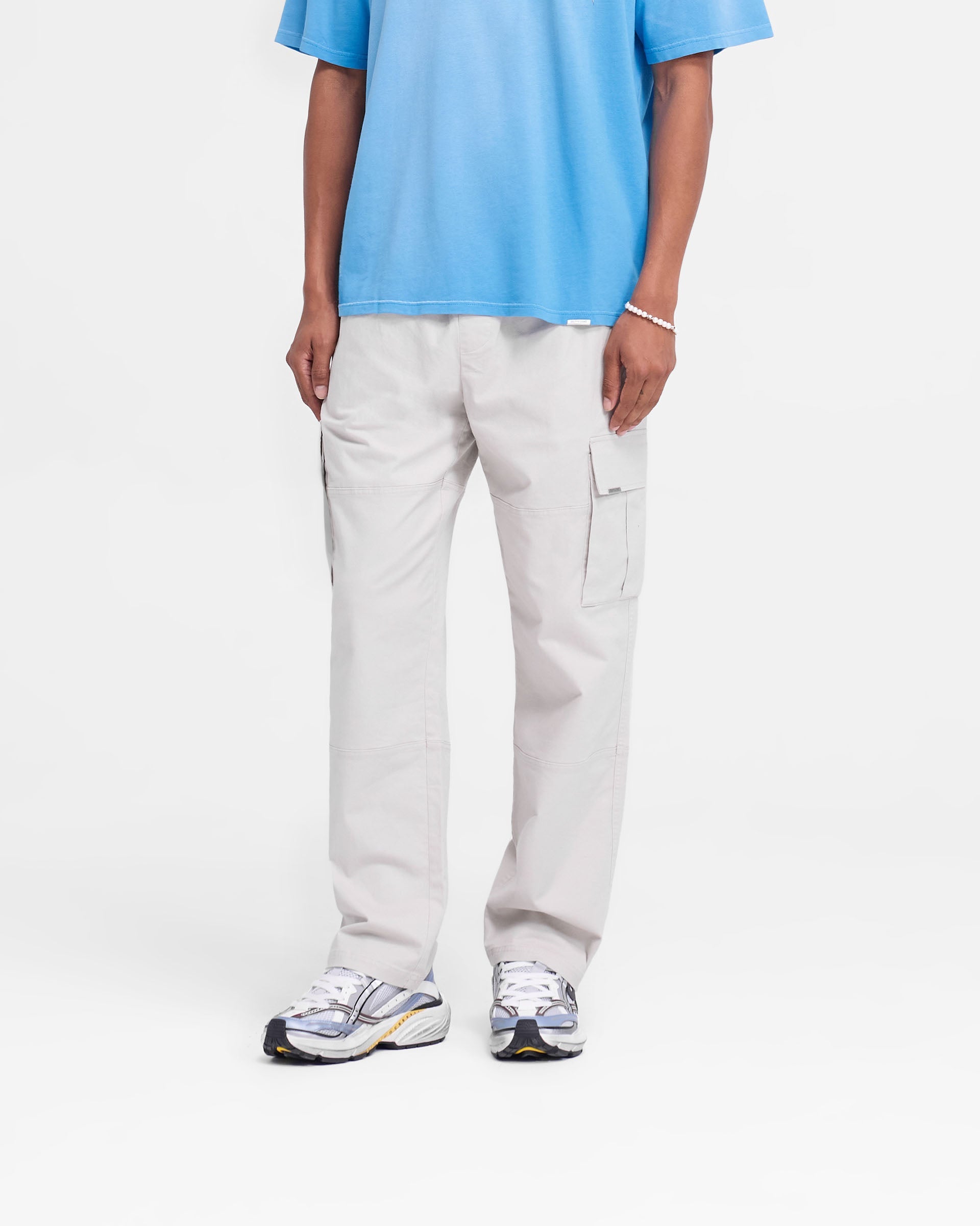 Back product image of mens stone cargo pants on a plain white background | Cargo Pant in Stone | Regular fit cargo pants with flap pockets and elasticated waistband | FW24 Pants | Represent Clo