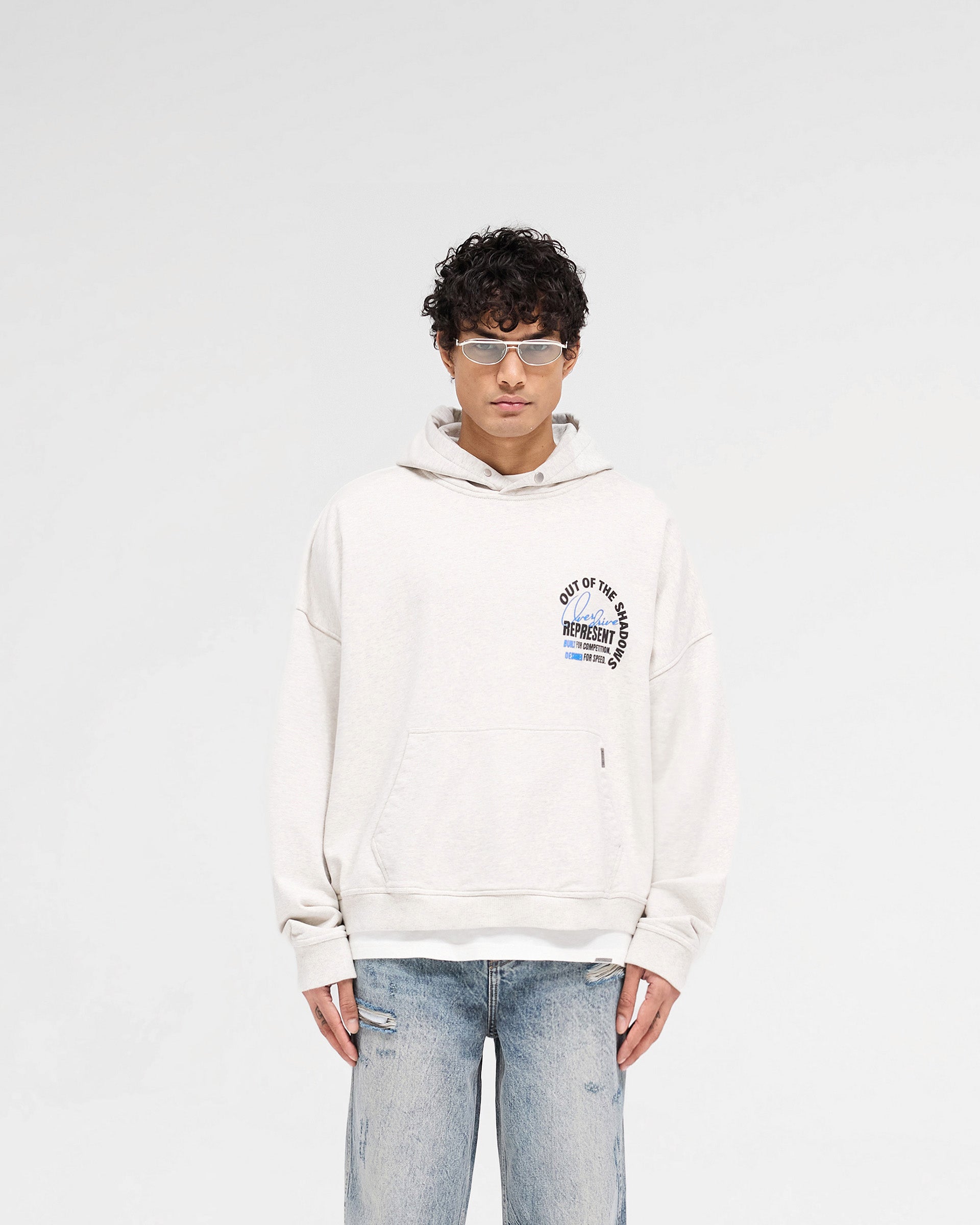 Man wearing a cream hoodie on a plain white background | Out Of The Shadows Hoodie in Cream Marl | Oversized boxy fit heavyweight hoodie | SS25 Hoodies | Represent Clo
