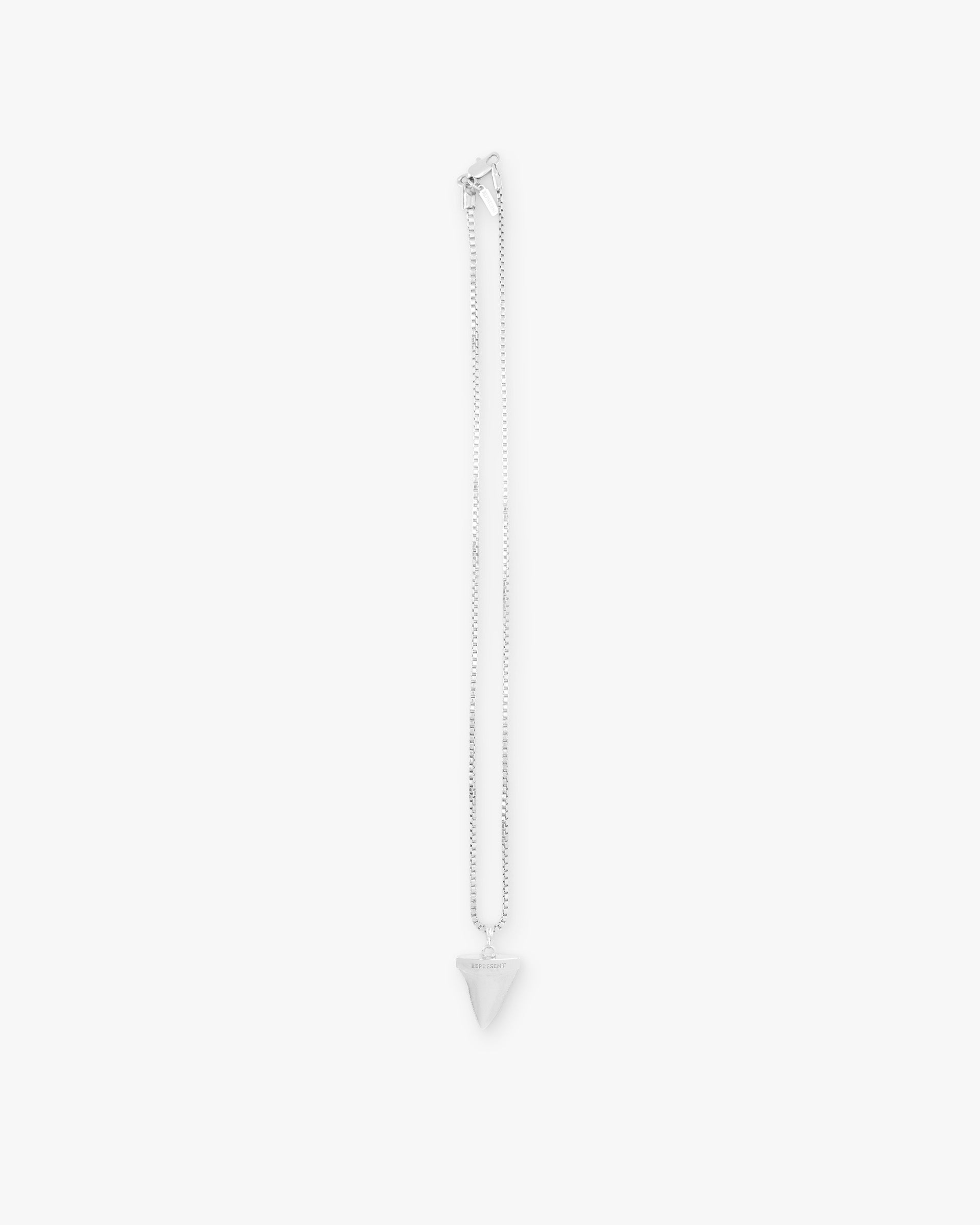 Front product image of a mens silver necklace on a plain white background | Shark Tooth Necklace in Silver | Silver necklace in shark tooth design | PRE SS25 Accessories | Represent Clo