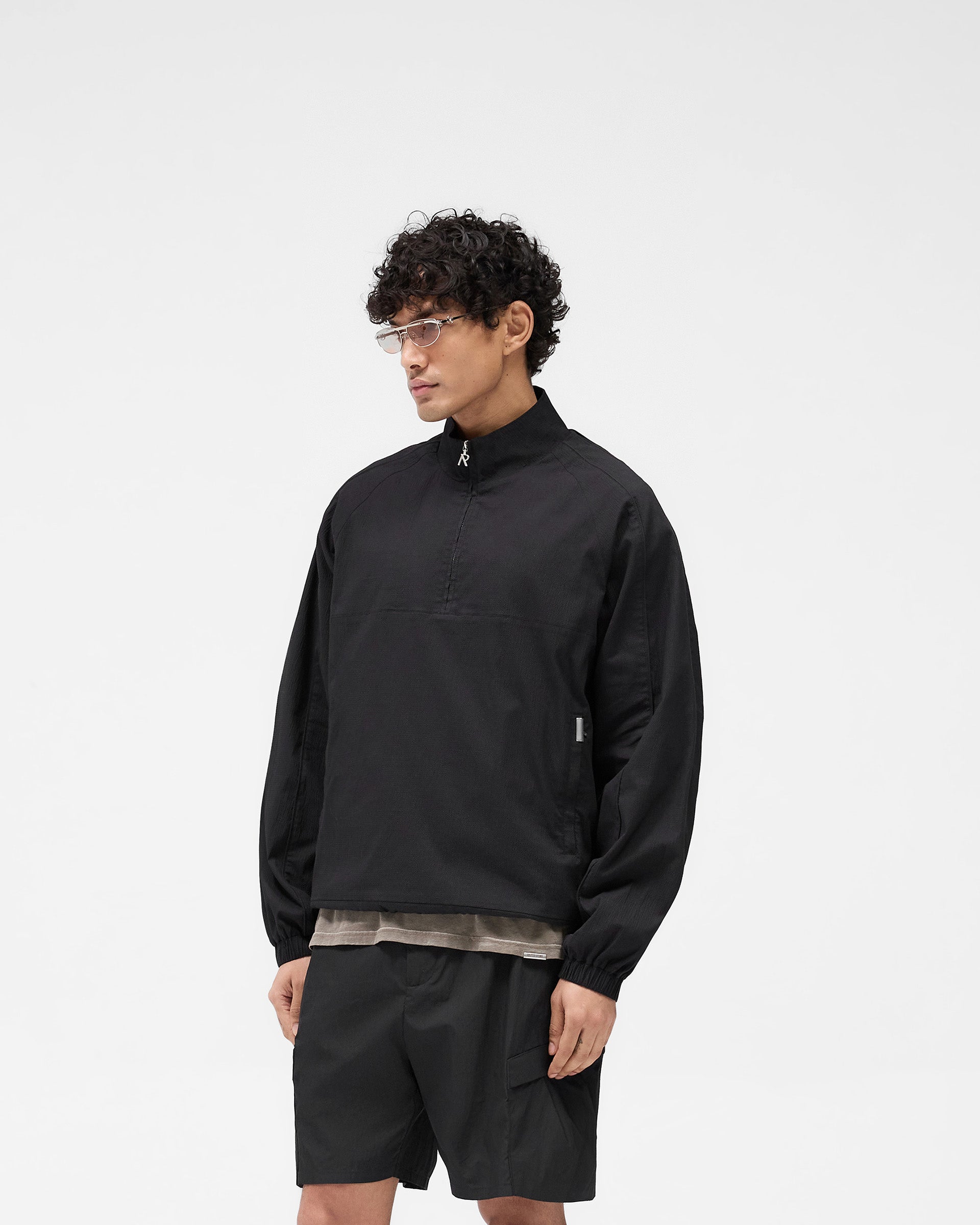 Back product image of a mens black jacket on a plain white background | Quarter Zip Jacket in Black | Lightweight outerwear with oversized silhouette and zip pockets | SS25 Outerwear | Represent Clo