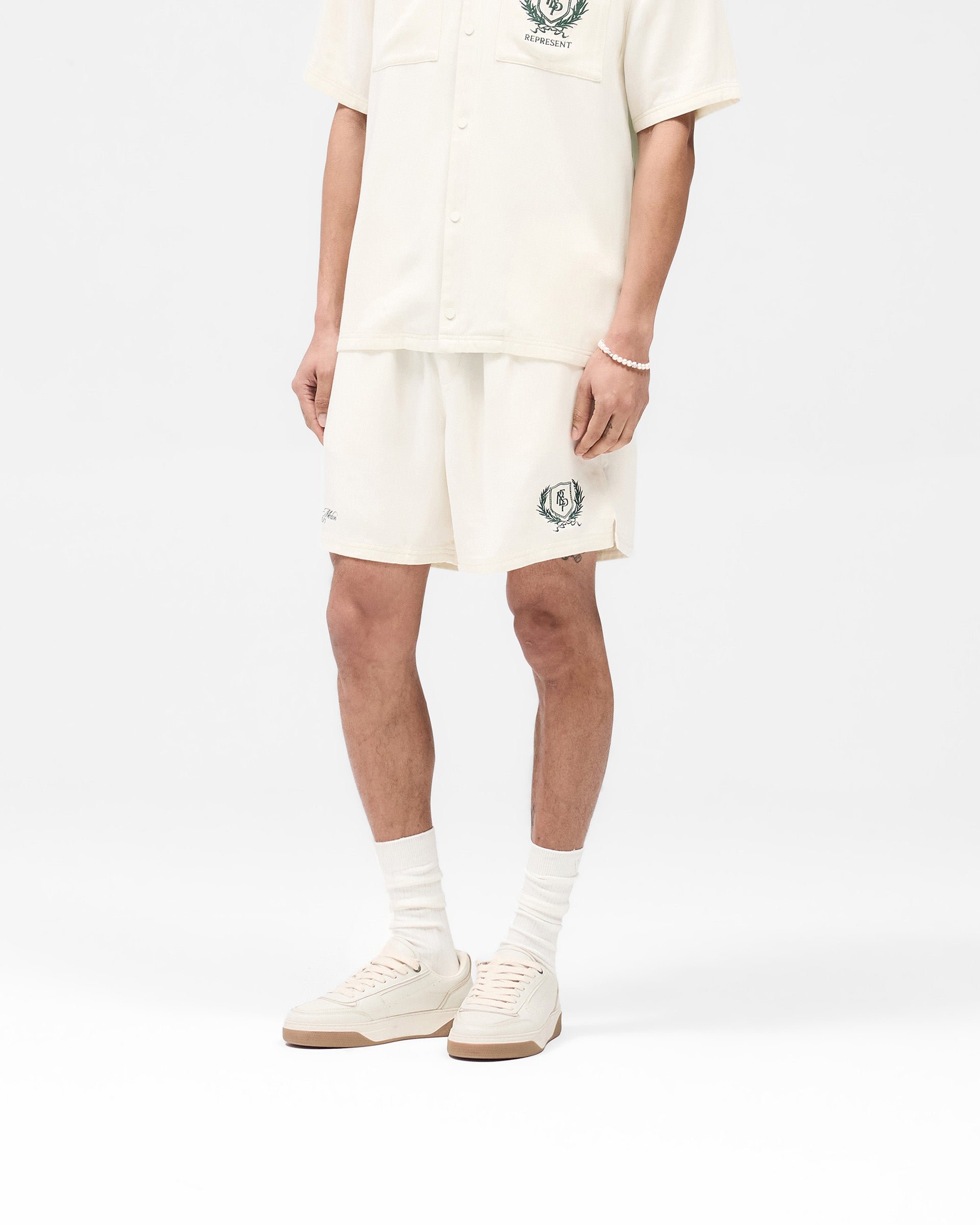 Back product image of mens antique white shorts on a plain white background | Represent Crest Short in Antique White | Shorts with crest branding and elasticated waistband | SS25 Shorts | Represent Clo