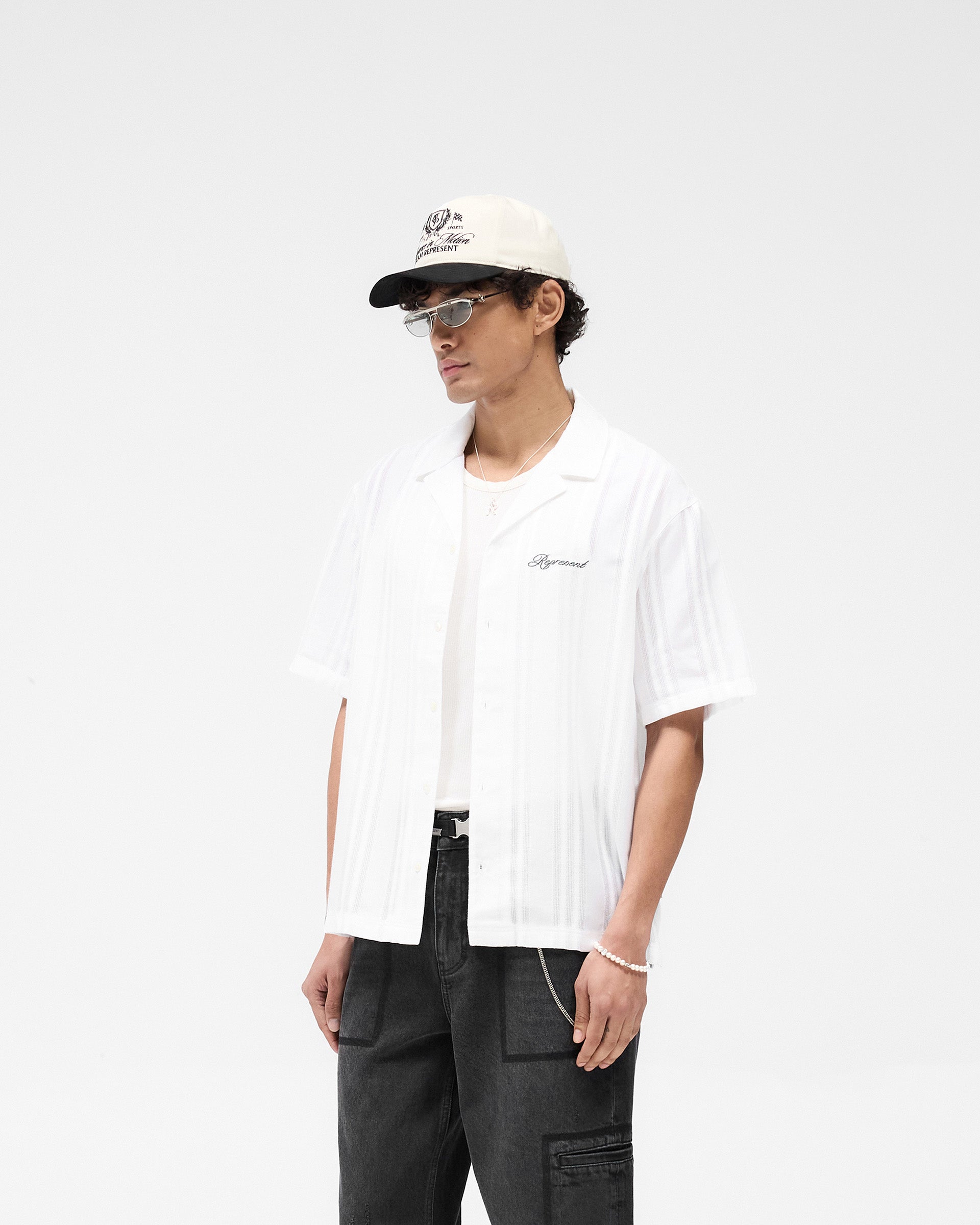 Back product image of a mens white shirt on a plain white background | Embroidered Bowling Shirt in Antique White | Sheer bowling shirt with button-down front | SS25 Shirts | Represent Clo