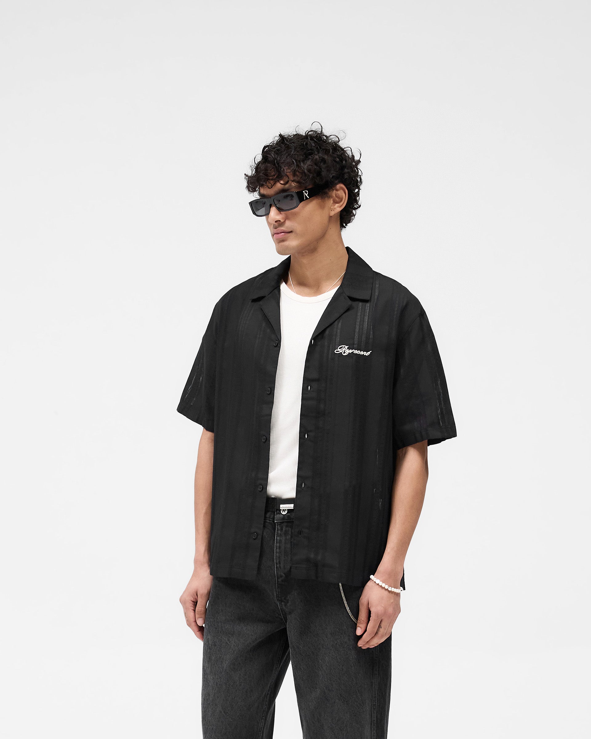 Back product image of a mens black bowling shirt on a plain white background | Embroidered Bowling Shirt in Jet Black | Sheer bowling shirt with embroidered logo | SS25 Shirts | Represent Clo
