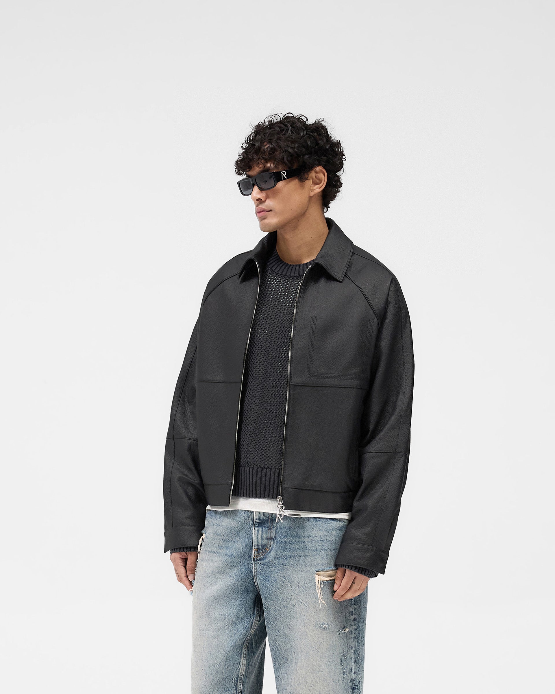 Back product image of a mens black leather jacket on a plain white background | Overdrive Leather Jacket in Black | Leather jacket with raglan-shaped sleeves and double-ended logo zip | SS25 Outerwear | Represent Clo