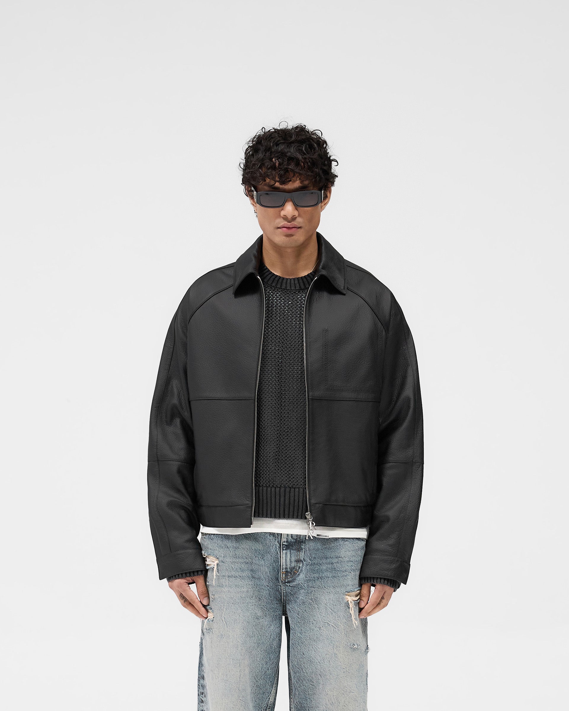 Man wearing a black leather jacket on a plain white background | Overdrive Leather Jacket in Black | Leather jacket with oversized proportions and premium detailing | SS25 Outerwear | Represent Clo