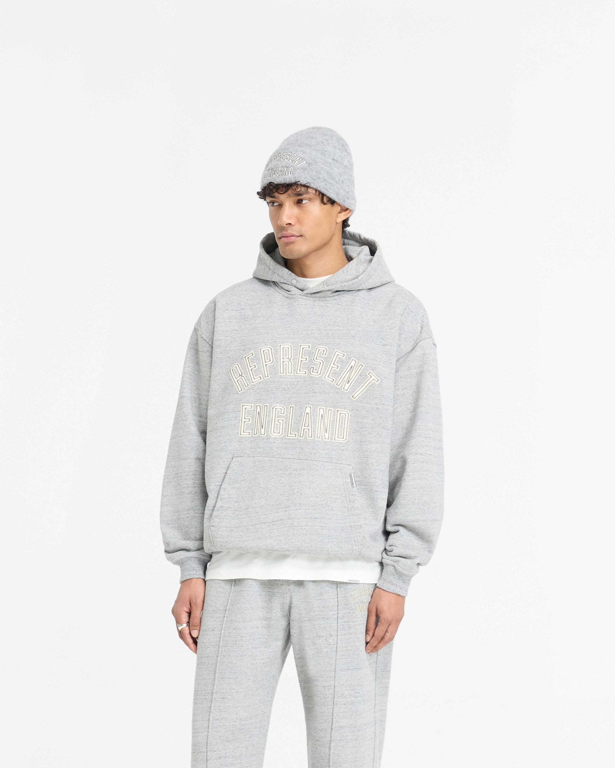 Back product image of a mens grey hoodie on a plain white background | England Applique Hoodie in Grey Marl | Oversized hoodie with embroidered applique | PRE SS25 Hoodies | Represent Clo