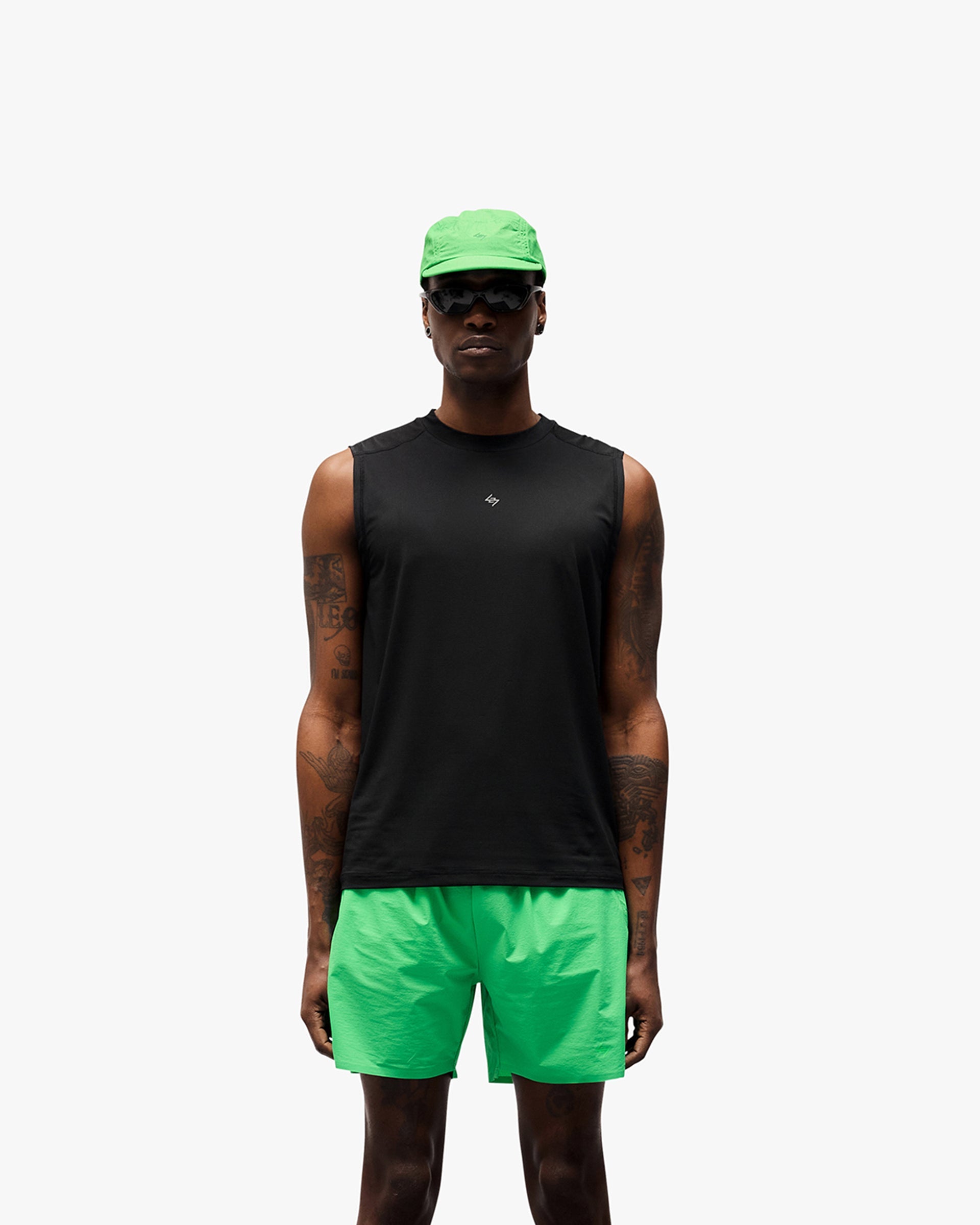 Man wearing a black running tank on a plain white background | 247 Contour Run Tank in Black | Breathable, sweat wicking mesh running tank | 247 T-Shirts | Represent Clo