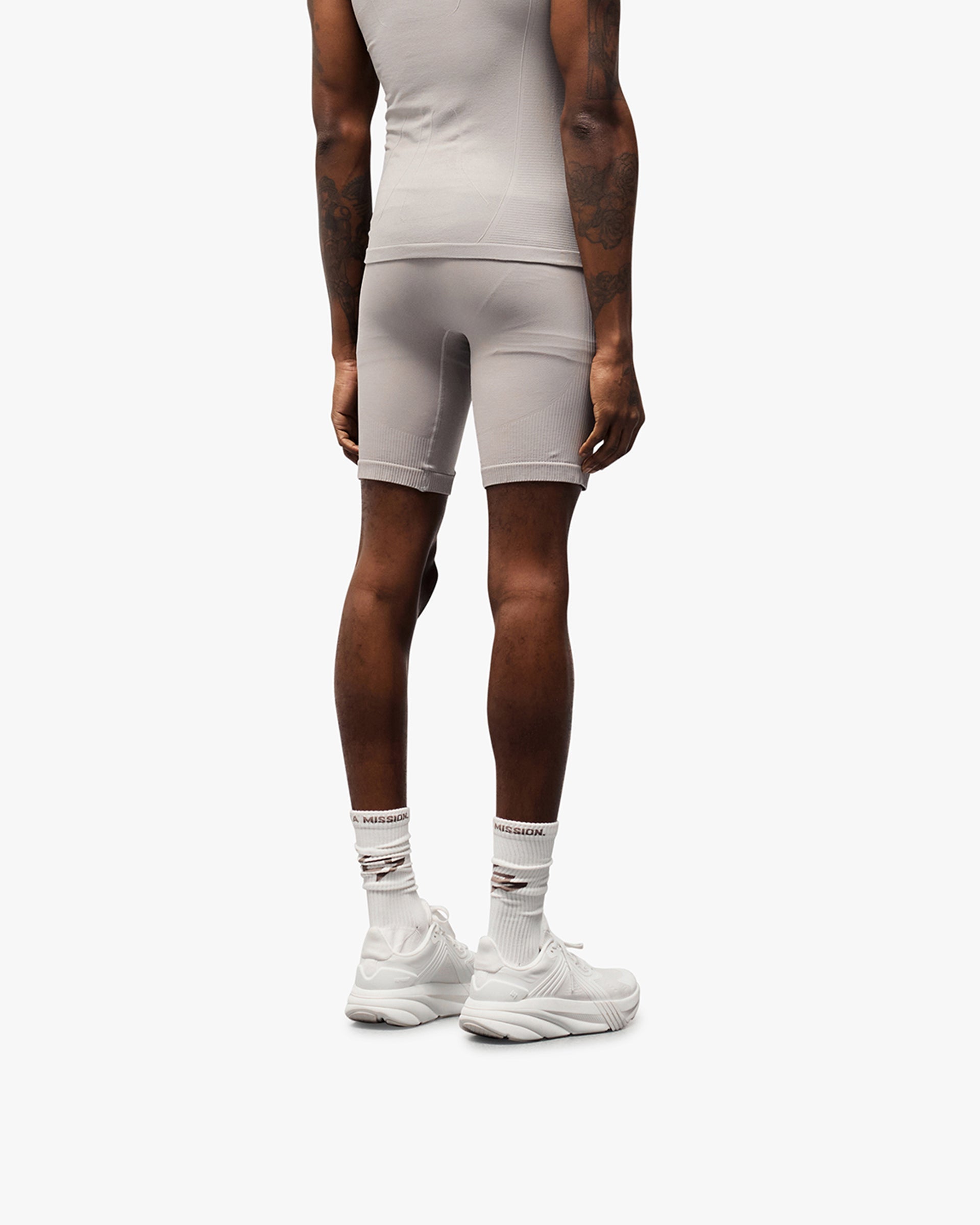Man wearing grey seamless shorts on a plain white background | 247 DNA Seamless Shorts in Titanium | Seamless shorts with knit structured panels | 247 Shorts | Represent Clo
