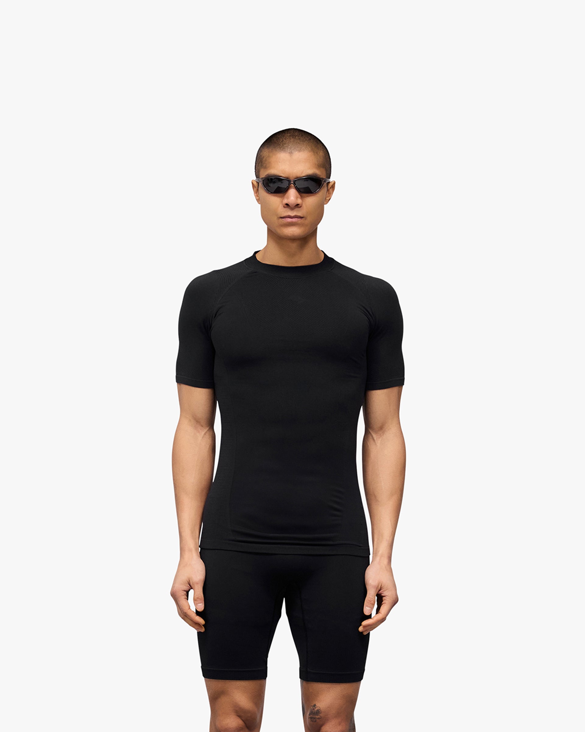 Man wearing a black t-shirt on a plain white background | 247 DNA Seamless T-Shirt in Black | Seamless t-shirt for optimal breathability and mobility | 247 T-Shirts | Represent Clo