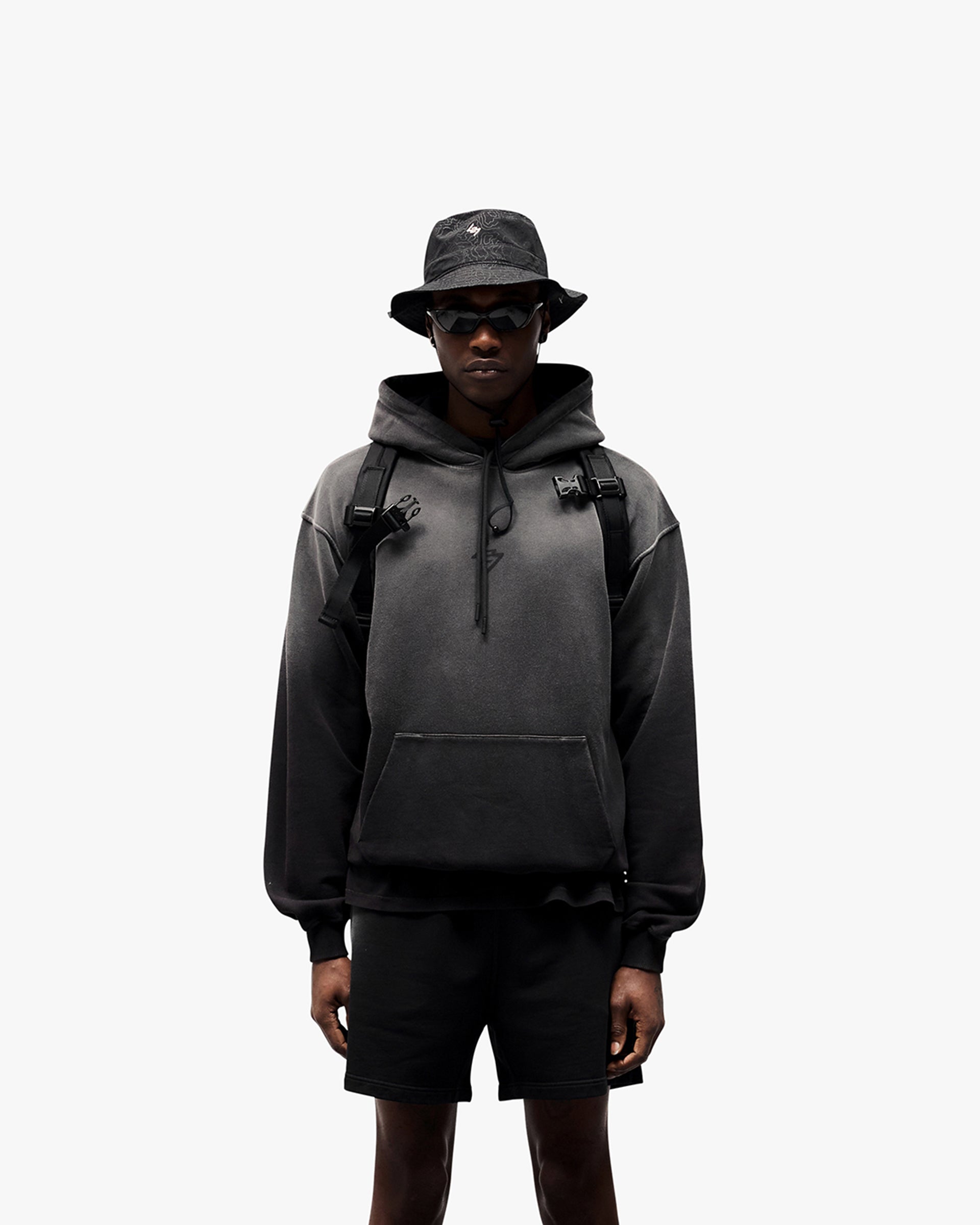 Man wearing an oversized black hoodie on a plain white background | 247 Motion Oversized Hoodie in Black | Oversized hoodie with ribbed hem and cuffs | 247 Hoodies | Represent Clo