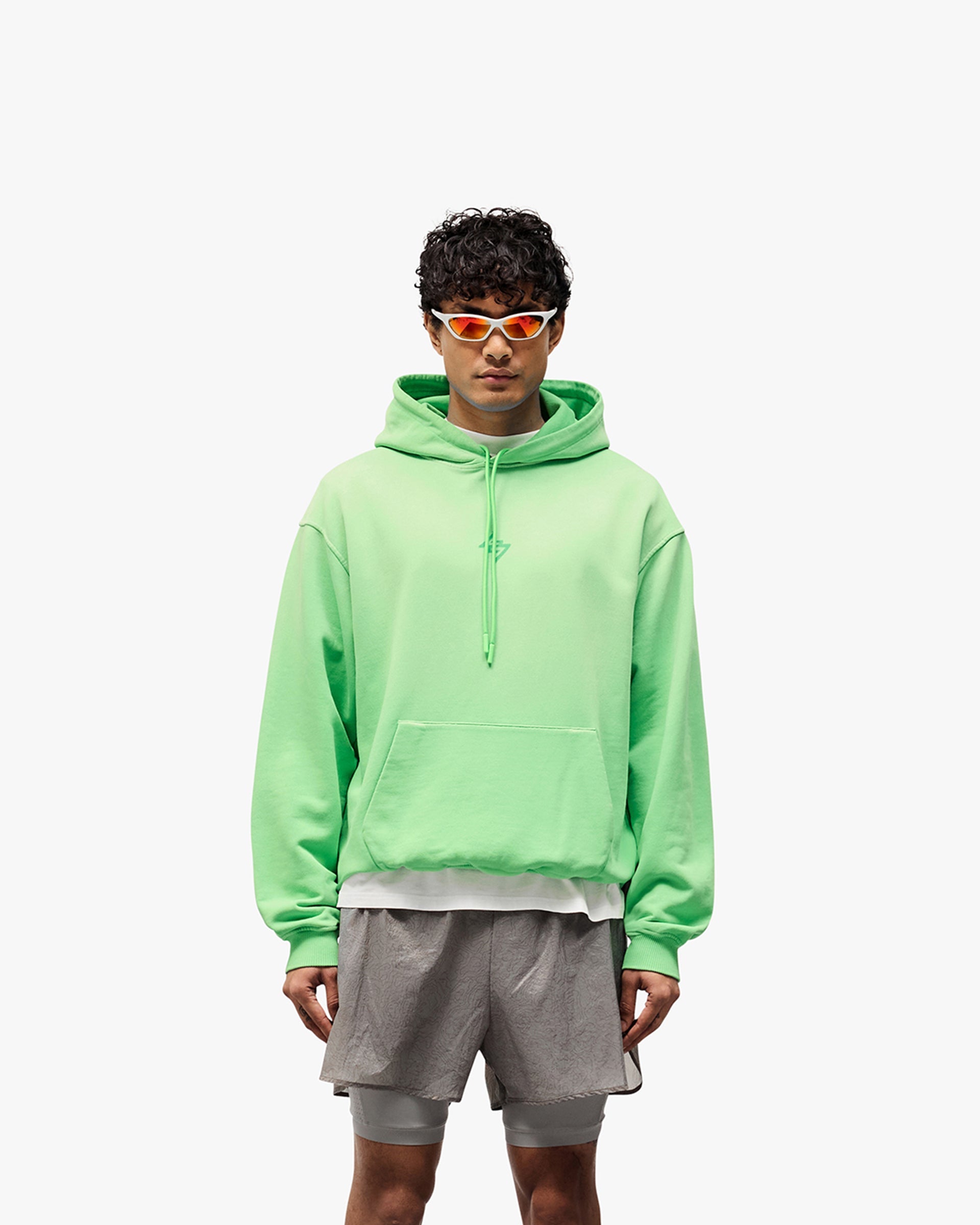 Man wearing an oversized green hoodie on a plain white background | 247 Motion Oversized Hoodie in Speed Green | Oversized hoodie with ribbed hem and cuffs | 247 Hoodies | Represent Clo