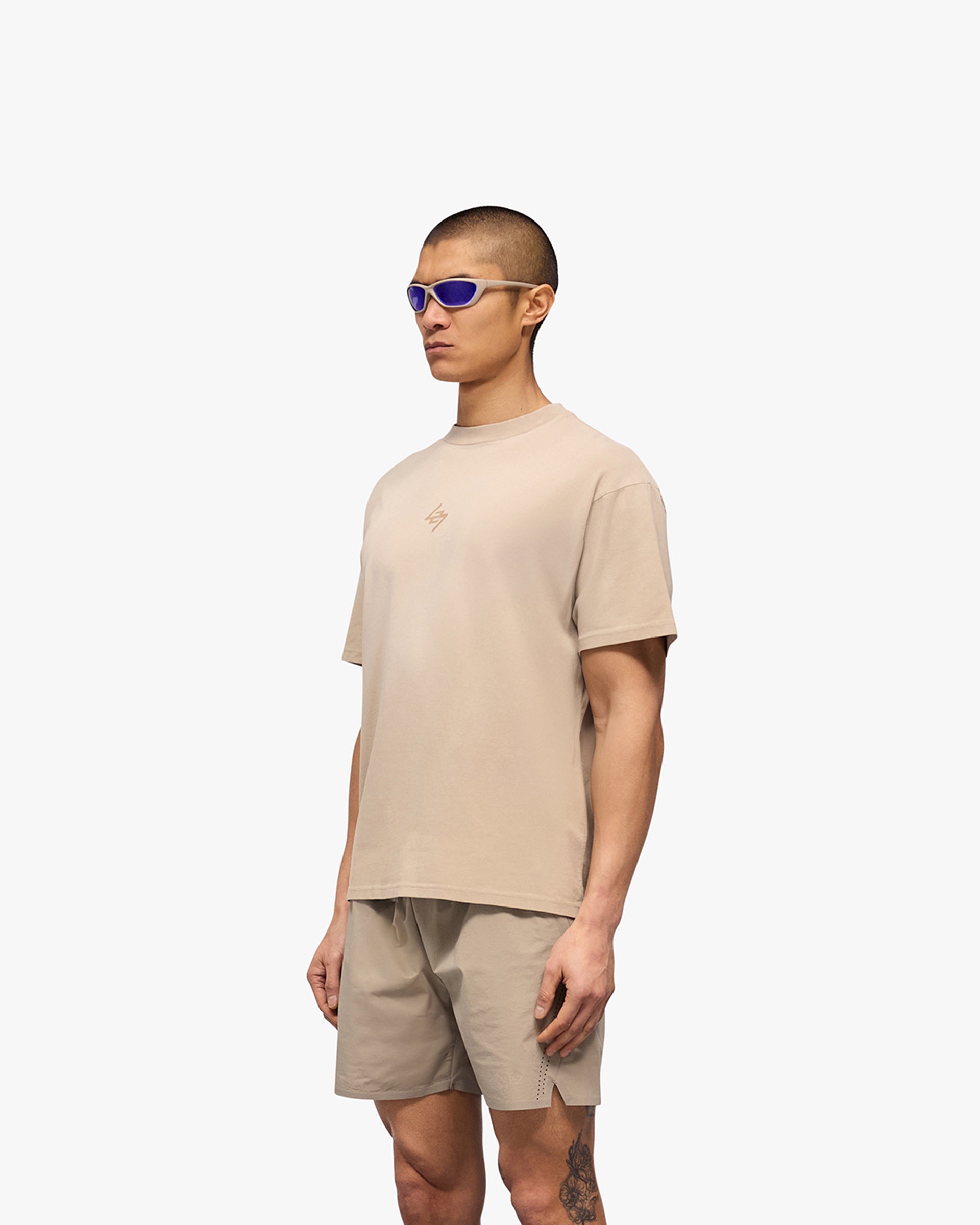 Man wearing an oversized grey t-shirt on a plain white background | 247 Motion Oversized T-Shirt in Pebble | Oversized t-shirt with 2 way stretch and antibacterial properties | 247 T-Shirts | Represent Clo