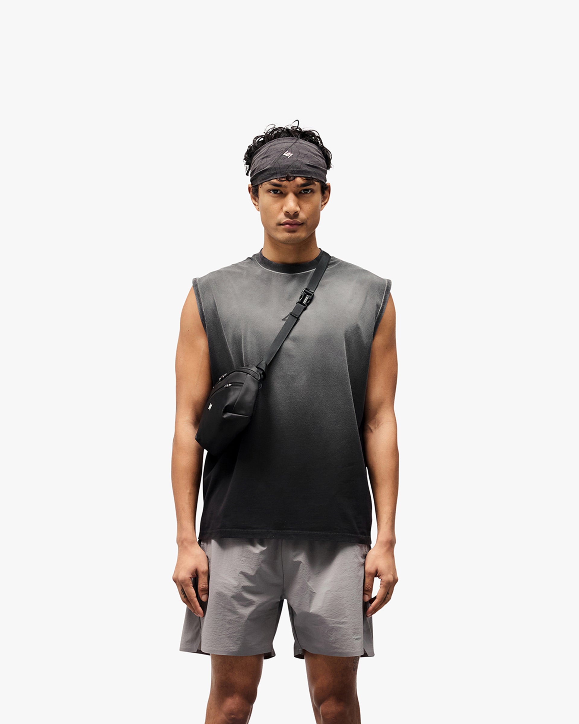 Man wearing a black oversized tank top on a plain white background | 247 Motion Oversized Tank in Aged Black | Oversized tank with 2 way stretch and vintage wash | 247 T-Shirts | Represent Clo