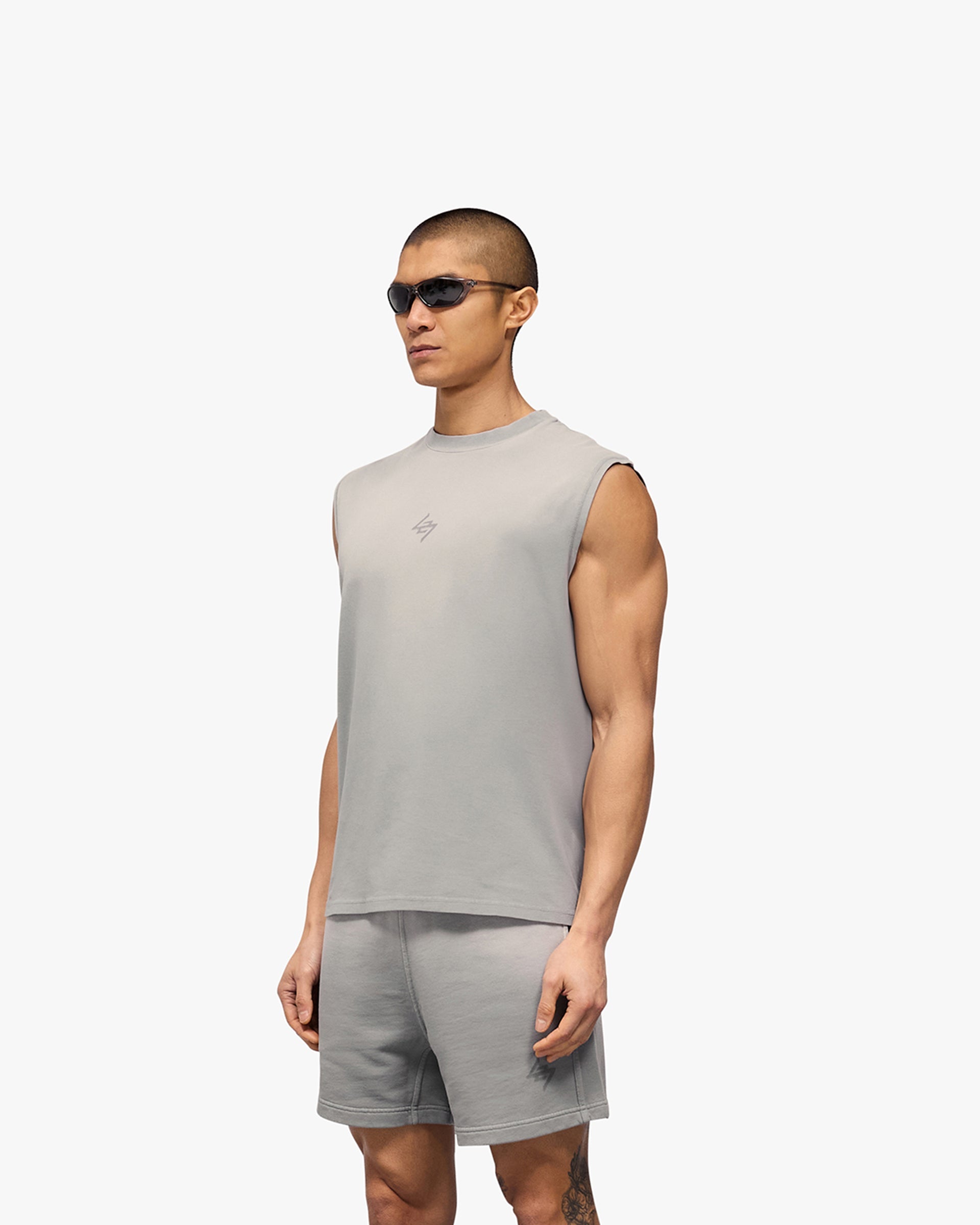 Man wearing an oversized grey tank on a plain white background | 247 Motion Oversized Tank in Titanium | Oversized tank with sweat wicking capabilities | 247 T-Shirts | Represent Clo
