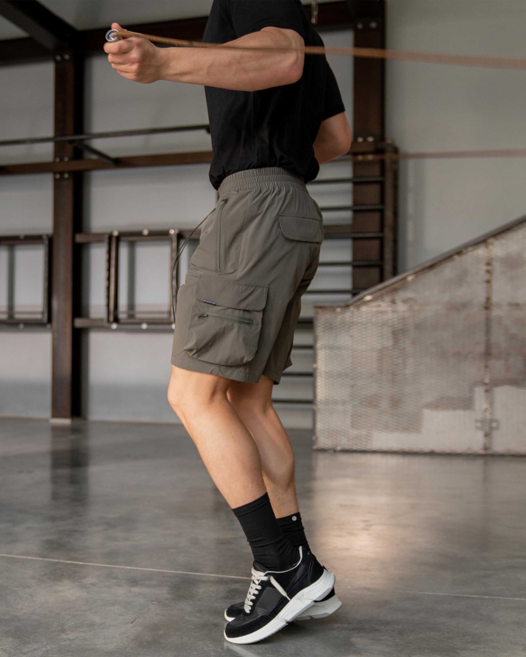Back product image of mens olive shorts on a plain white background | 247 Shorts in Olive | Mens combat shorts with cargo leg pockets | 247 Shorts | Represent Clo