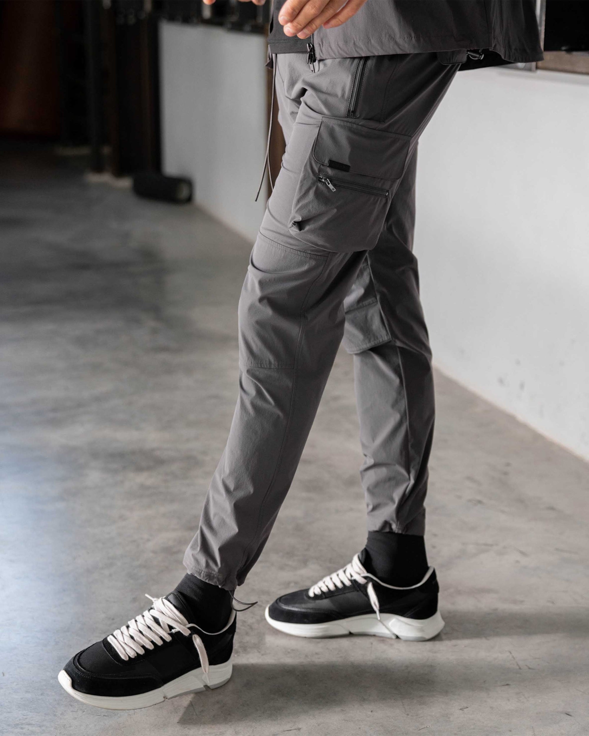 Back product image of mens grey pants on a plain white background | 247 Pant in Grey | Cargo pants with dual pockets and adjustable hems | 247 Pants | Represent Clo