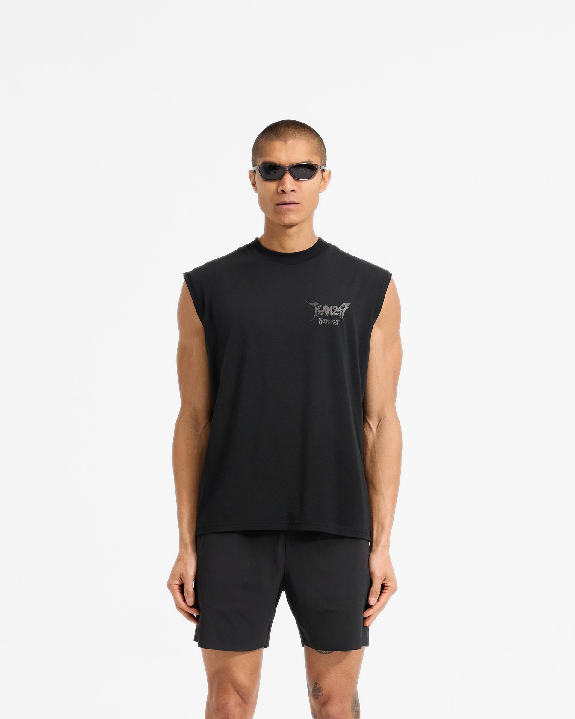 Man wearing an oversized black tank on a plain white background | Team 247 X END Oversized Tank in Jet Black | Oversized tank with Drirelease fabric and co-branded graphics | 247 T-Shirts | Represent Clo