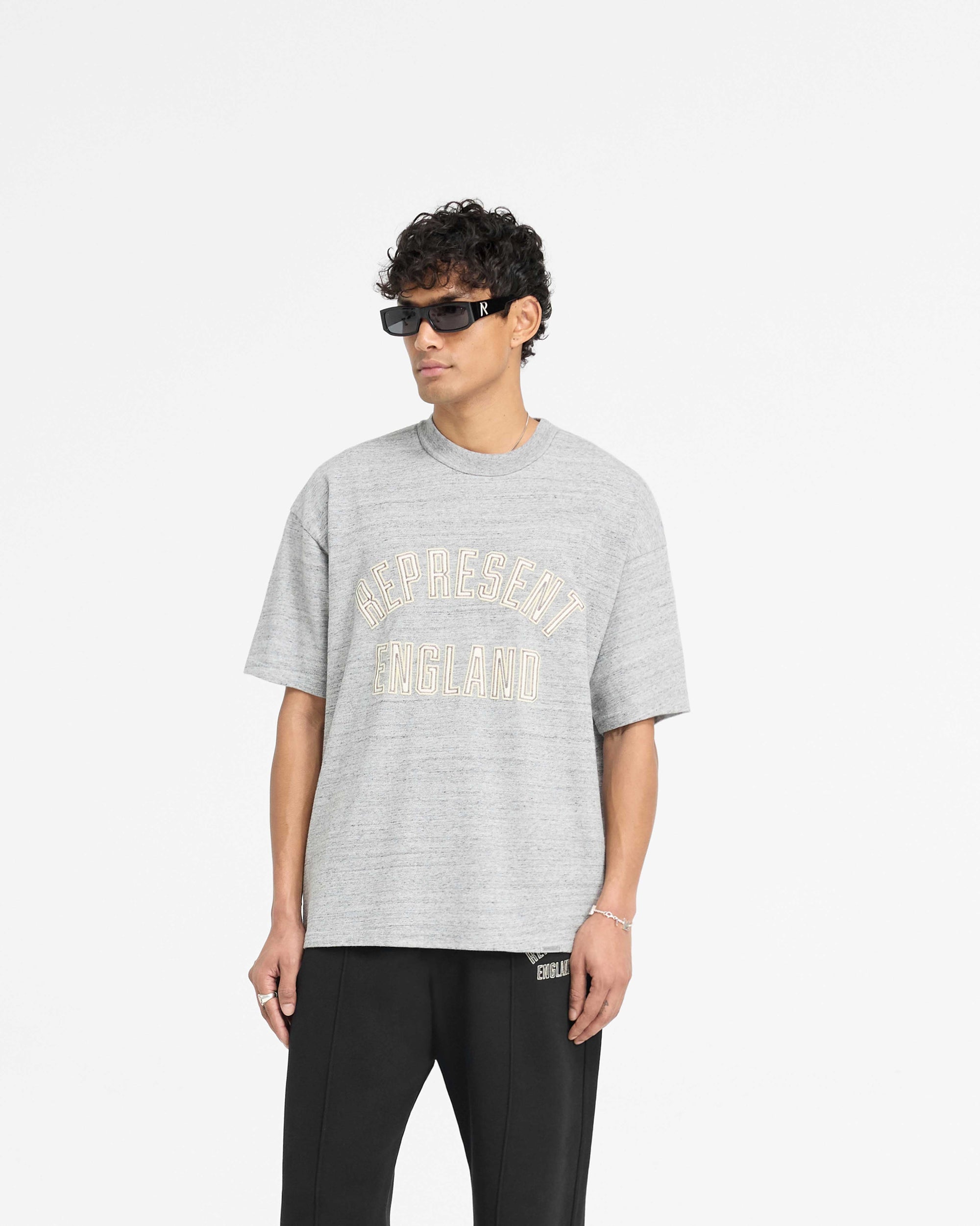 Back product image of a mens grey t-shirt on a plain white background | England Applique T-Shirt in Grey Marl | Slightly oversized t-shirt with applique embroidery | PRE SS25 T-Shirts | Represent Clo