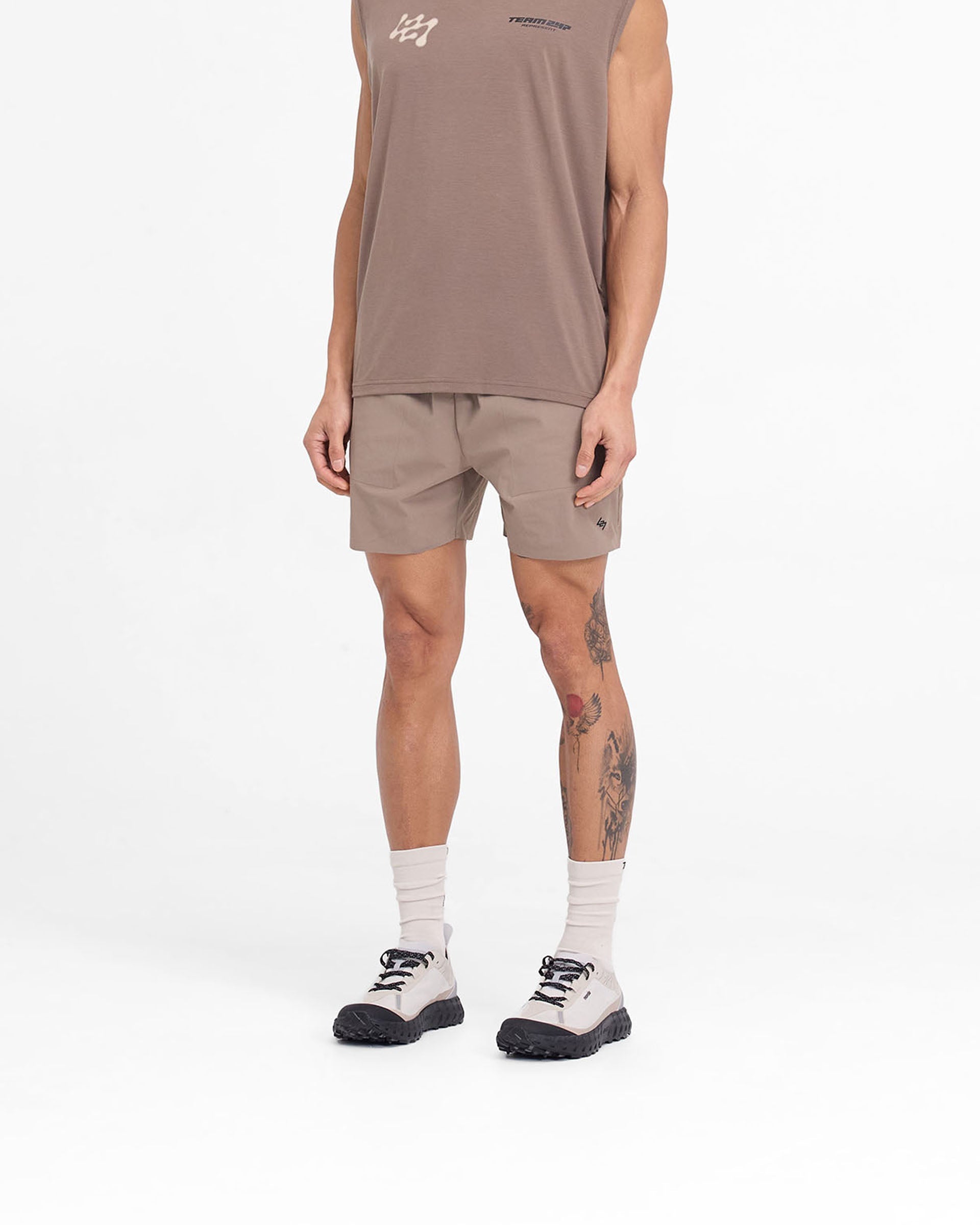 Man wearing umber training shorts on a plain white background | Team 247 Fused Shorts in Umber | Recycled nylon shorts with branded waistband | 247 Shorts | Represent Clo