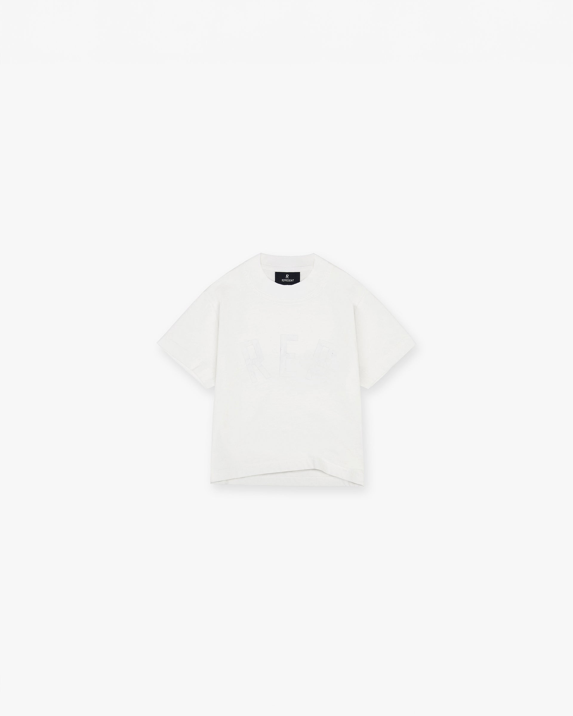 Front product image of a childs white t-shirt on a plain white background | Mini Rep Applique T-Shirt in Flat White | Childs t-shirt with oversized fit | FW24 T-Shirts | Represent Clo